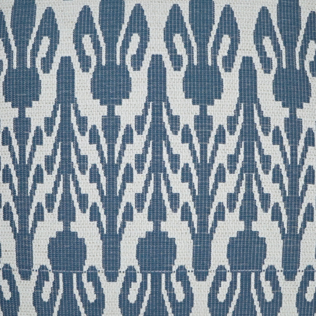 Indigo blue woven fabric with a repeating floral trellis pattern on an off-white background.