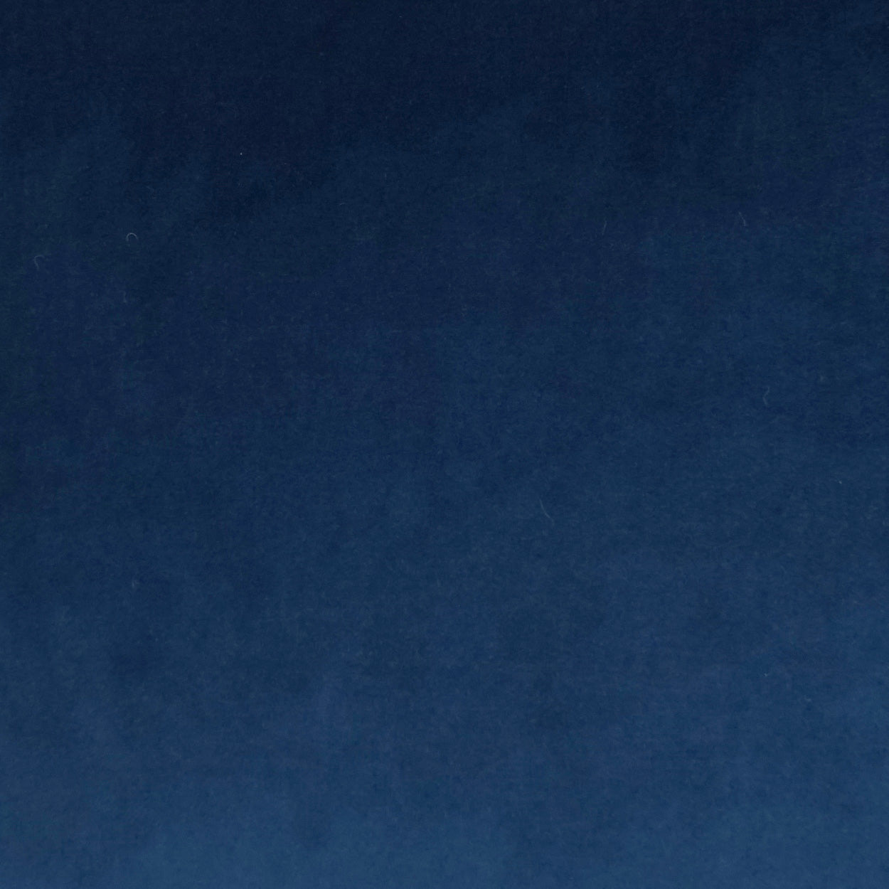 Deep blue fabric texture close-up, soft nap and subtle color variation.