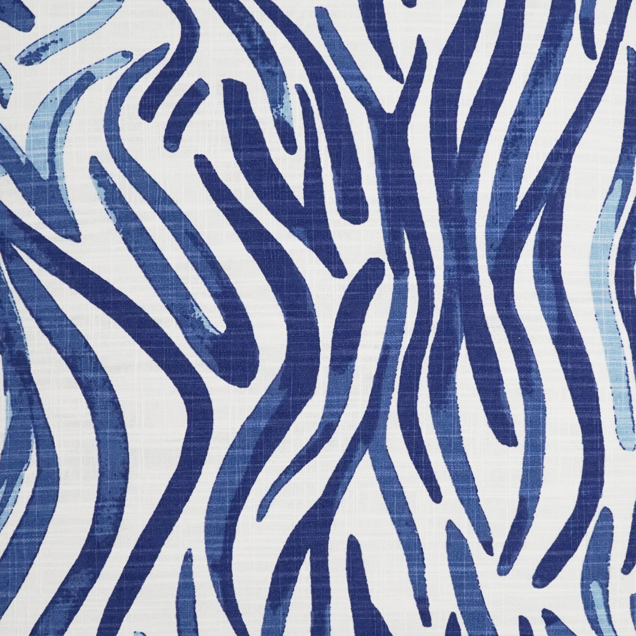 Blue and white zebra-striped fabric with a bold abstract pattern.