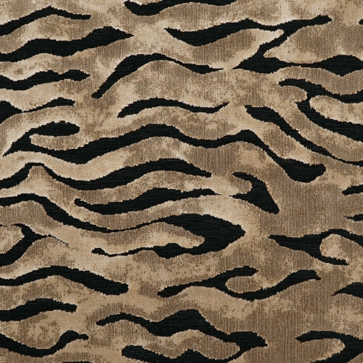 Beige fabric with irregular black wavy tiger-stripe pattern; plush textile for upholstery or rugs.