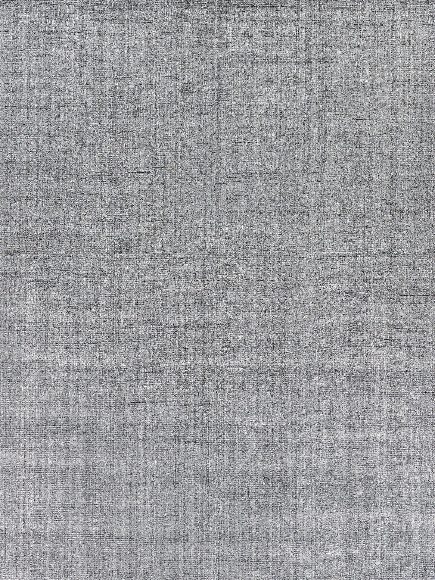Grey hand-loomed indoor rug with a textured weave and subtle crosshatch pattern.