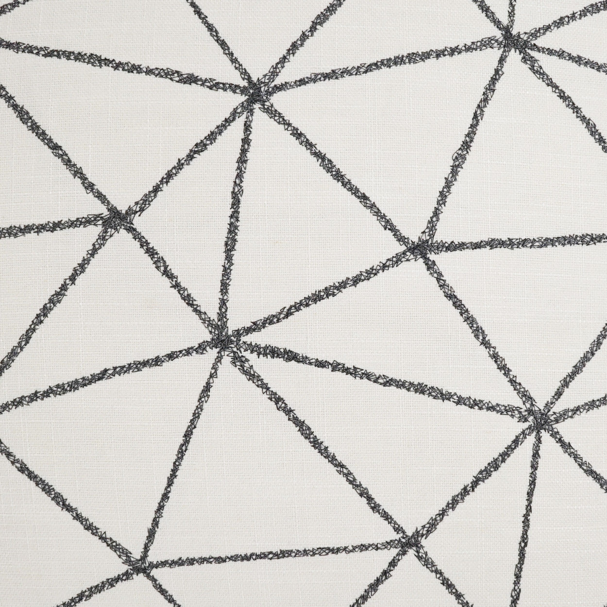 Cream fabric with black chalk-line geometric triangles; modern abstract pattern for upholstery & decor.