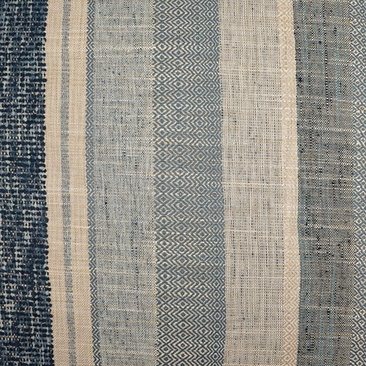 Blue and beige striped woven pillow with a geometric pattern; 24 x 24 inches.