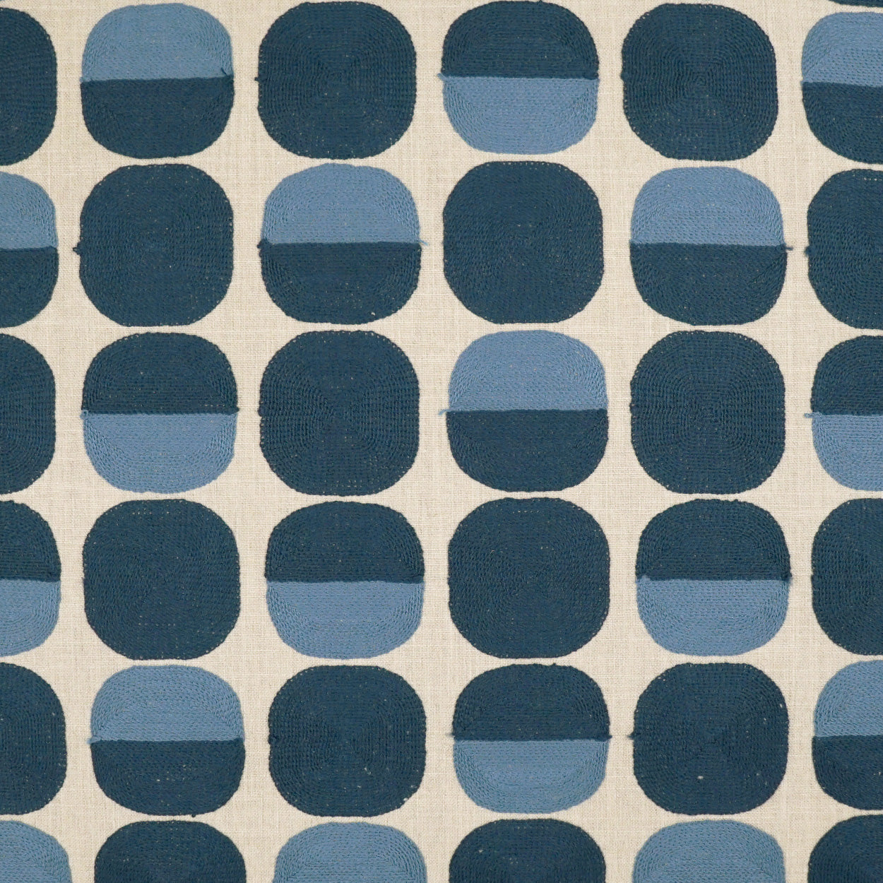 Two-tone blue rounded-square fabric pattern on beige background.