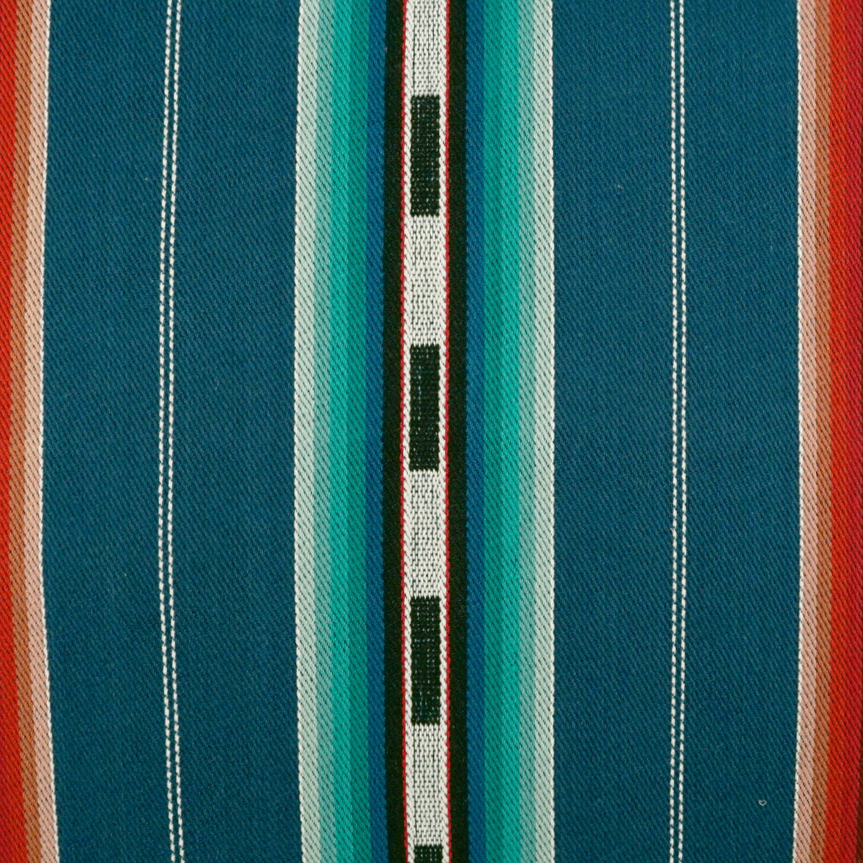 Pillow 24" x 24" with teal and blue striped woven fabric, central white stripe and black rectangular accents.