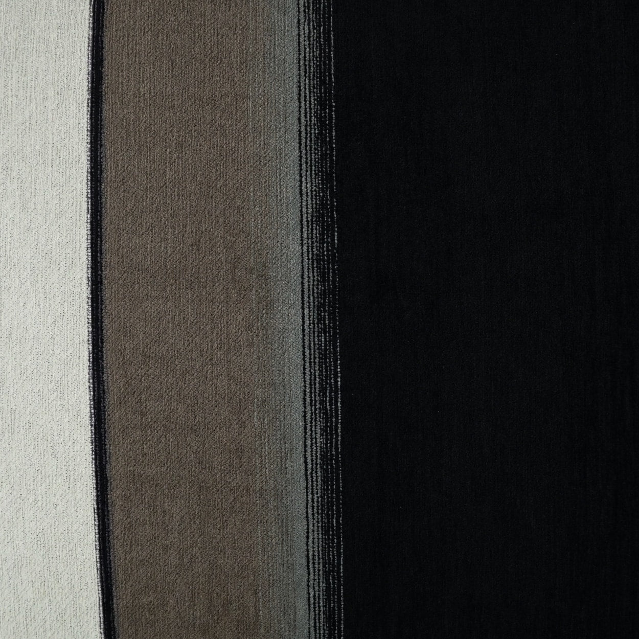 Striped fabric swatch in cream, taupe, gray & black panels; woven texture & vertical stripe design.