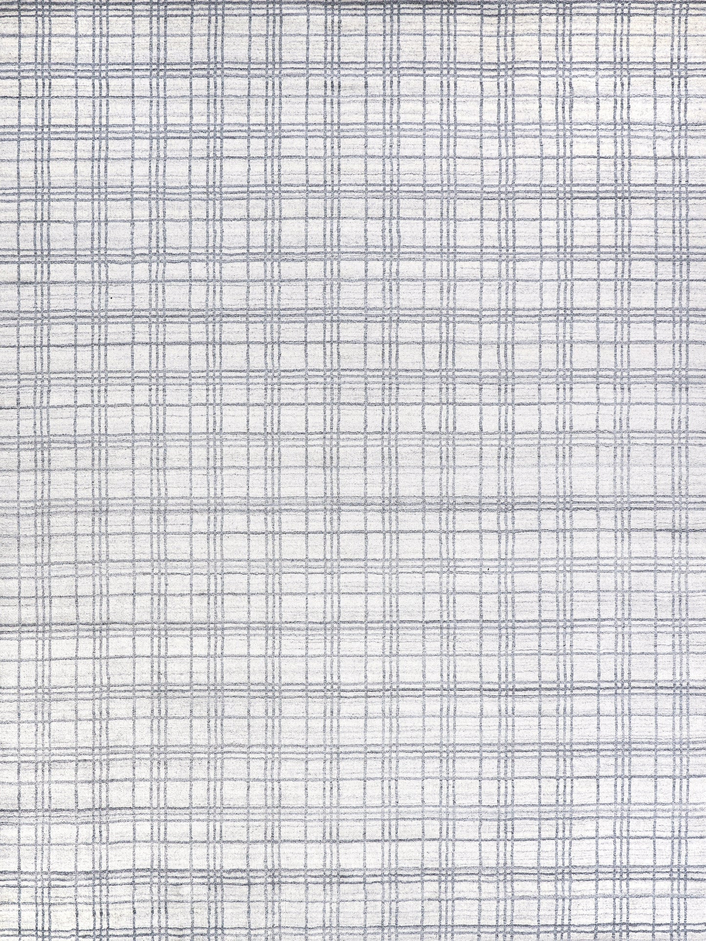 Lightly textured rug with a white base and subtle blue plaid pattern.