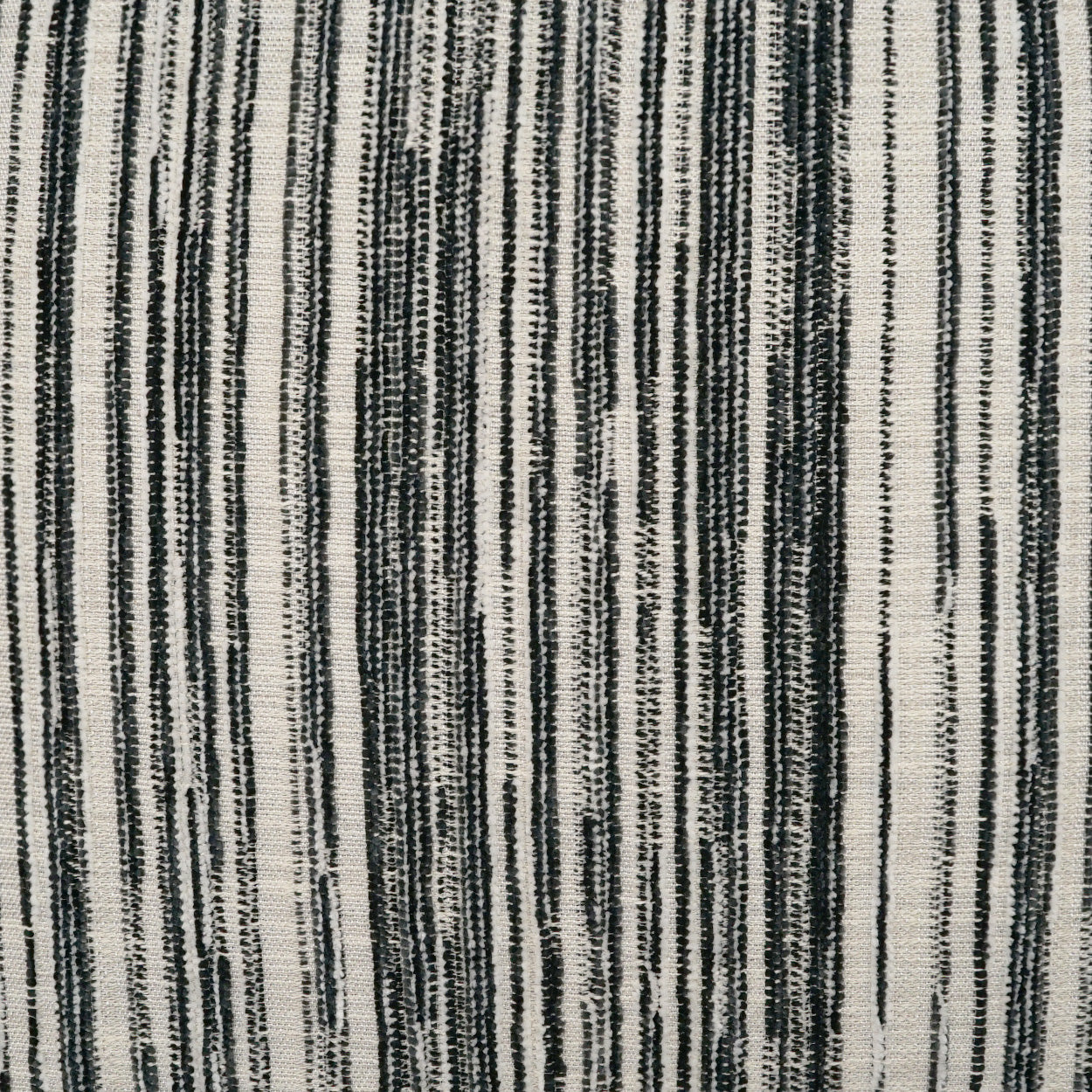 Vertical striped woven fabric in black and ivory with textured, irregular stripe widths.