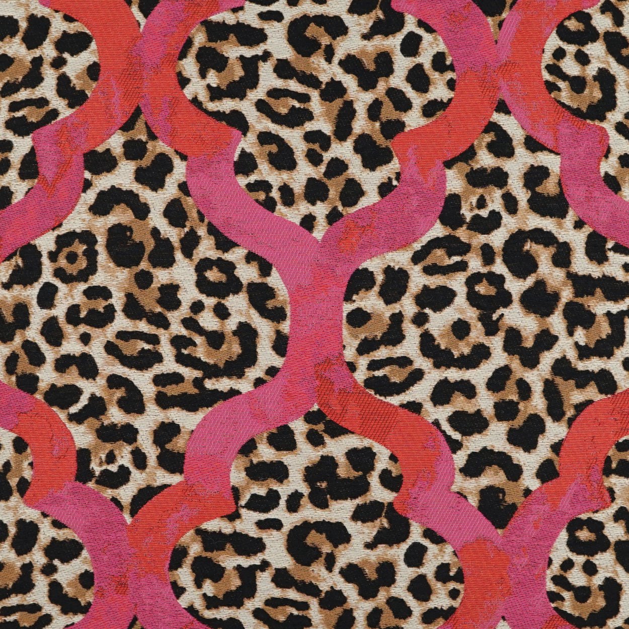 Pillow with leopard print and bold pink interlocking curved lattice pattern.