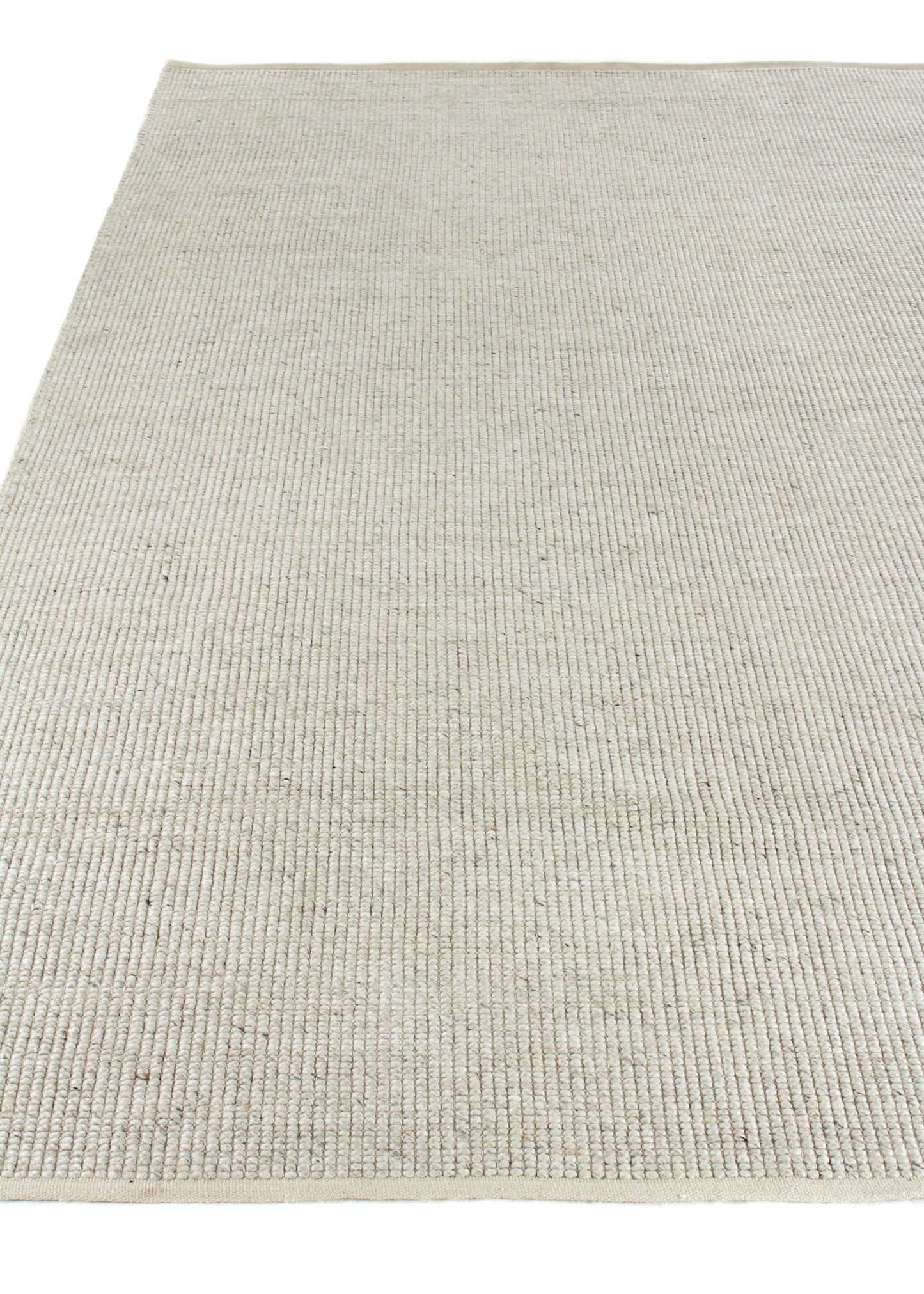 Beige natural-fiber hand-woven rug with subtle ribbed texture and narrow border.
