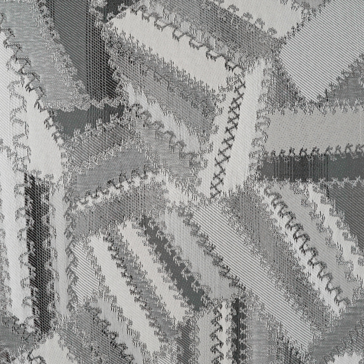 Charcoal and white patchwork pillow with fabric strips, zigzag overlock seams and textured weave, 24" x 24