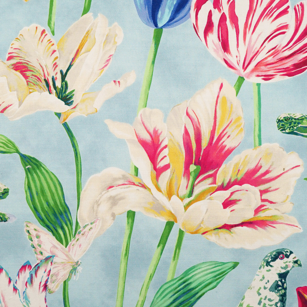 Bright floral fabric with large multi-color tulips in pink, yellow, blue, and white on a light blue background.