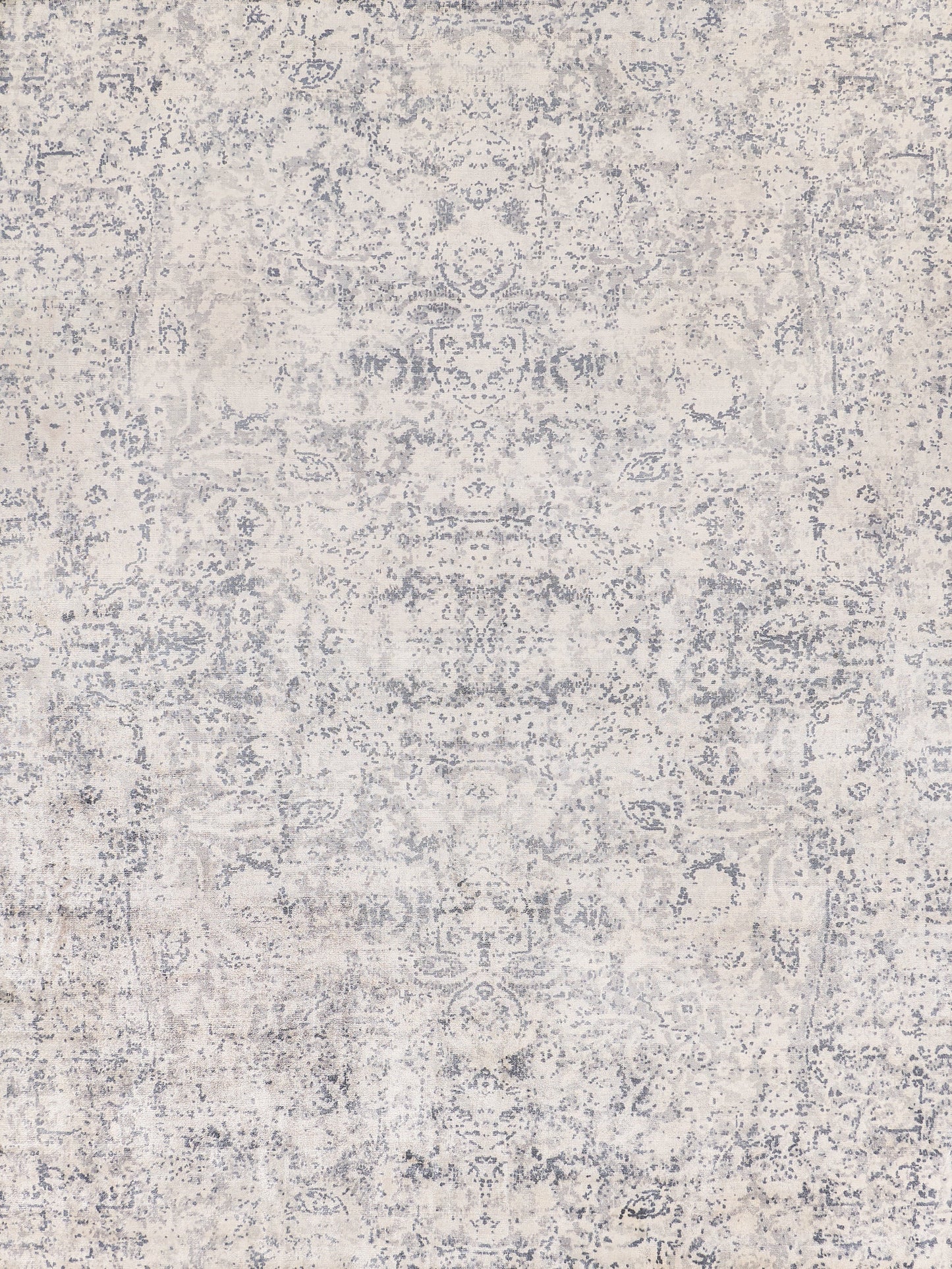 Faded vintage-style area rug in light cream with delicate gray patterns, perfect for adding elegance to any room.