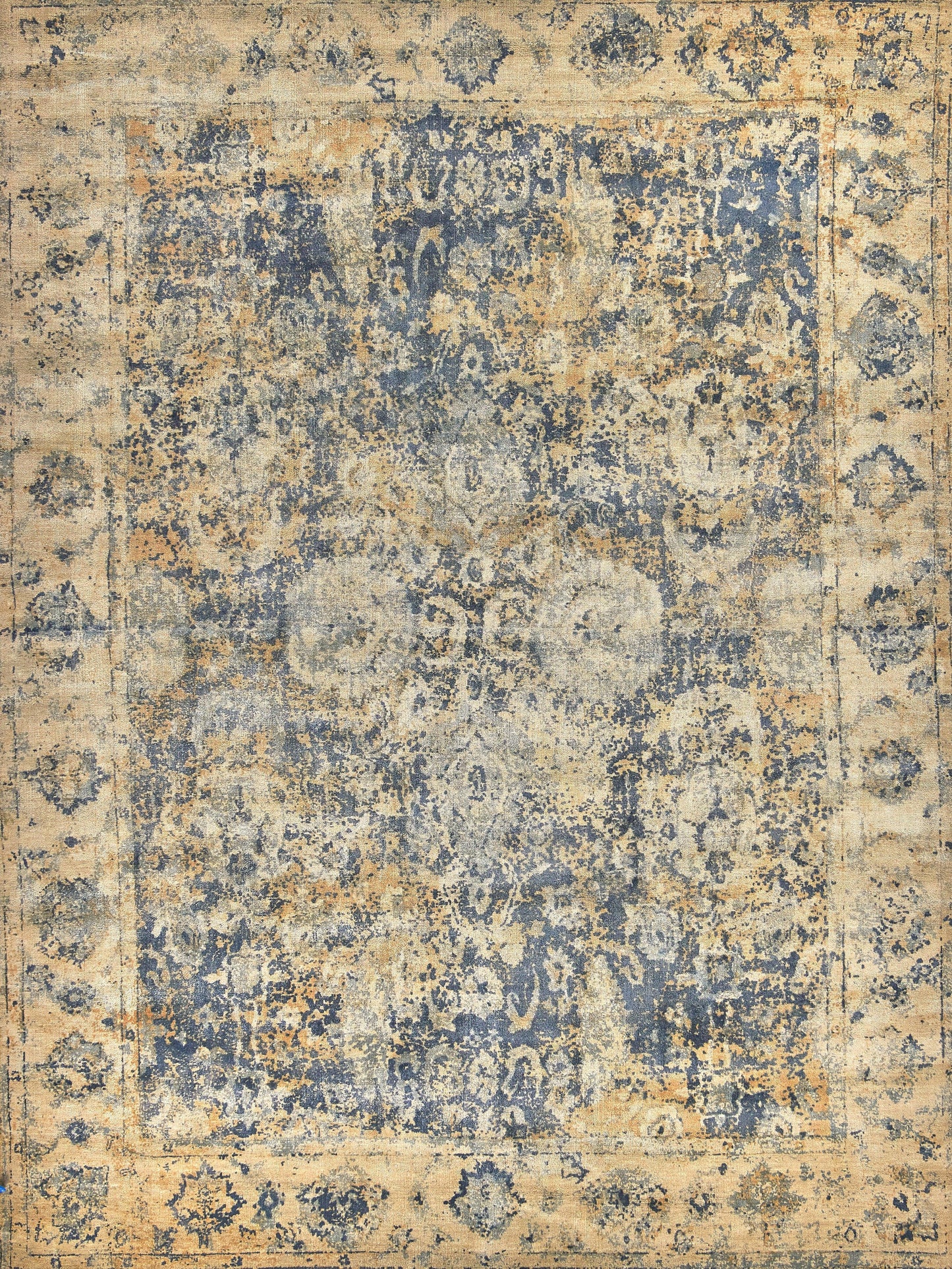 Faded blue and beige area rug with intricate floral patterns, aged texture, rectangular shape.