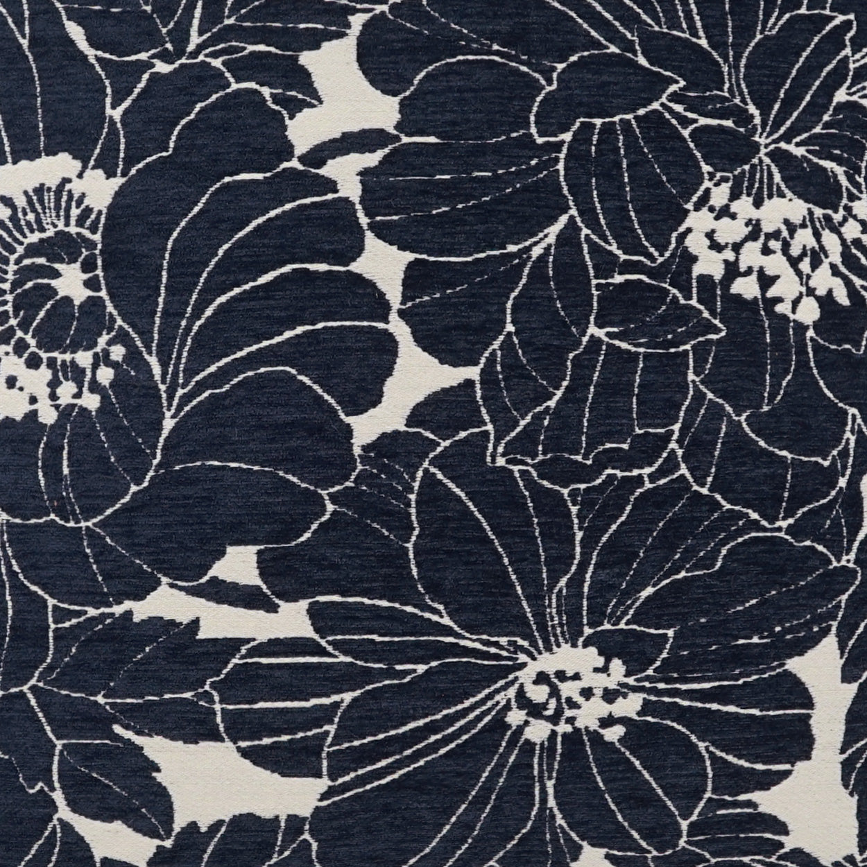Navy floral fabric with large light-outline blooms on a cream-beige background and a woven texture