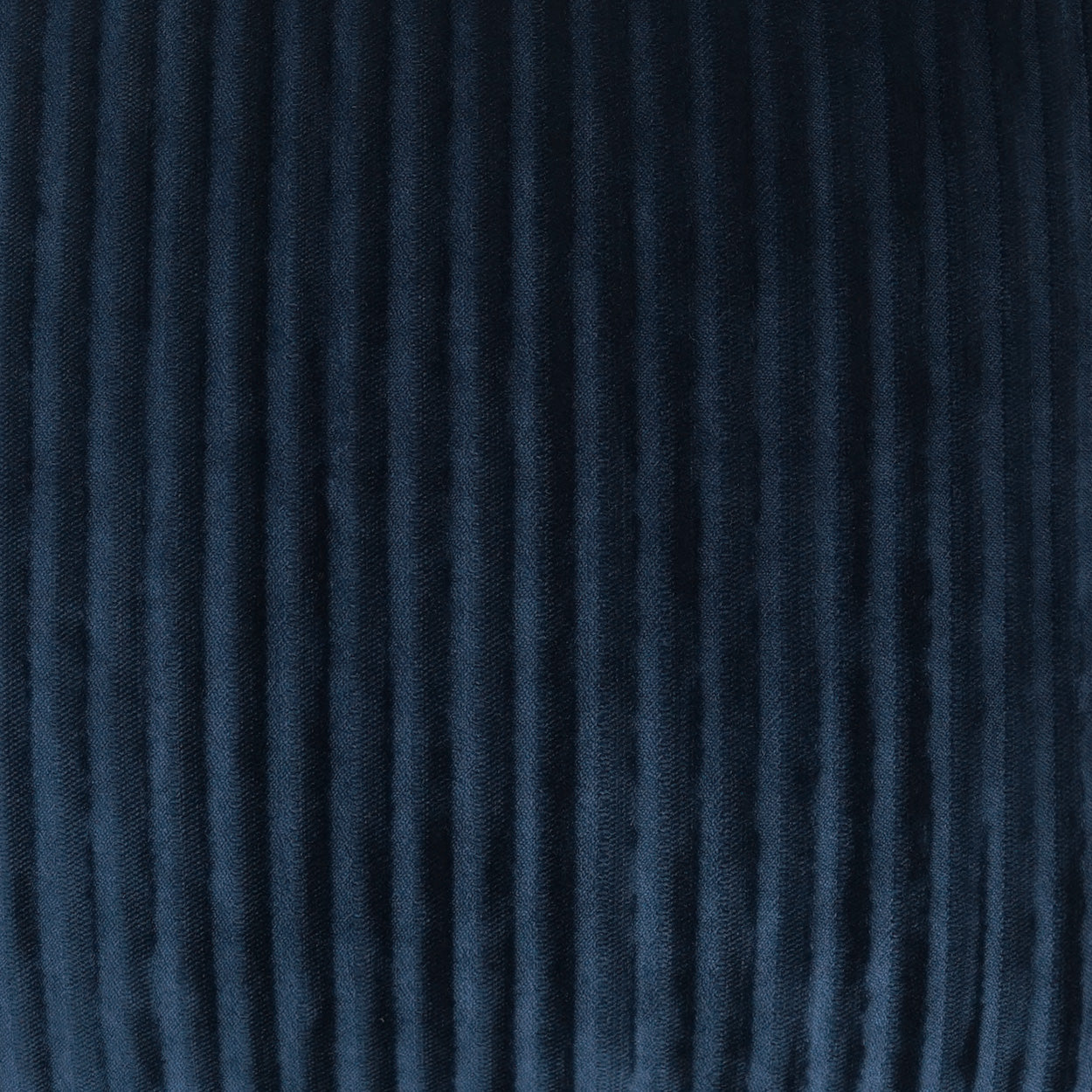 Deep navy corduroy fabric with narrow vertical wales and plush texture, ideal for jackets or upholstery.