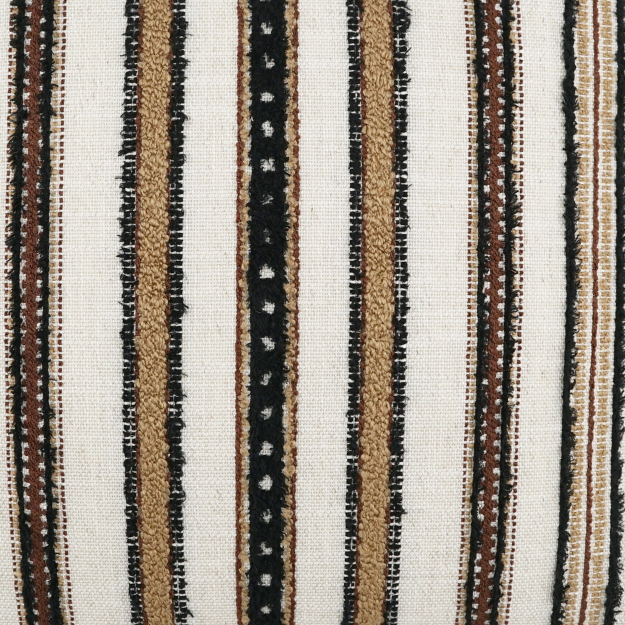 Woven striped rug in ivory with black, tan and brown vertical stripes; rustic textured textile.