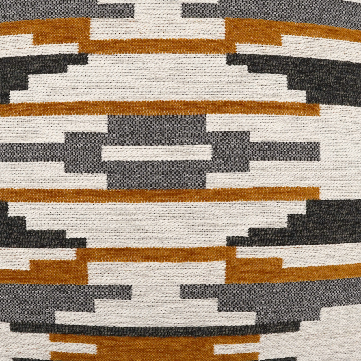 Close-up of a woven geometric textile with stepped stripes in cream, gray, rust, and black.