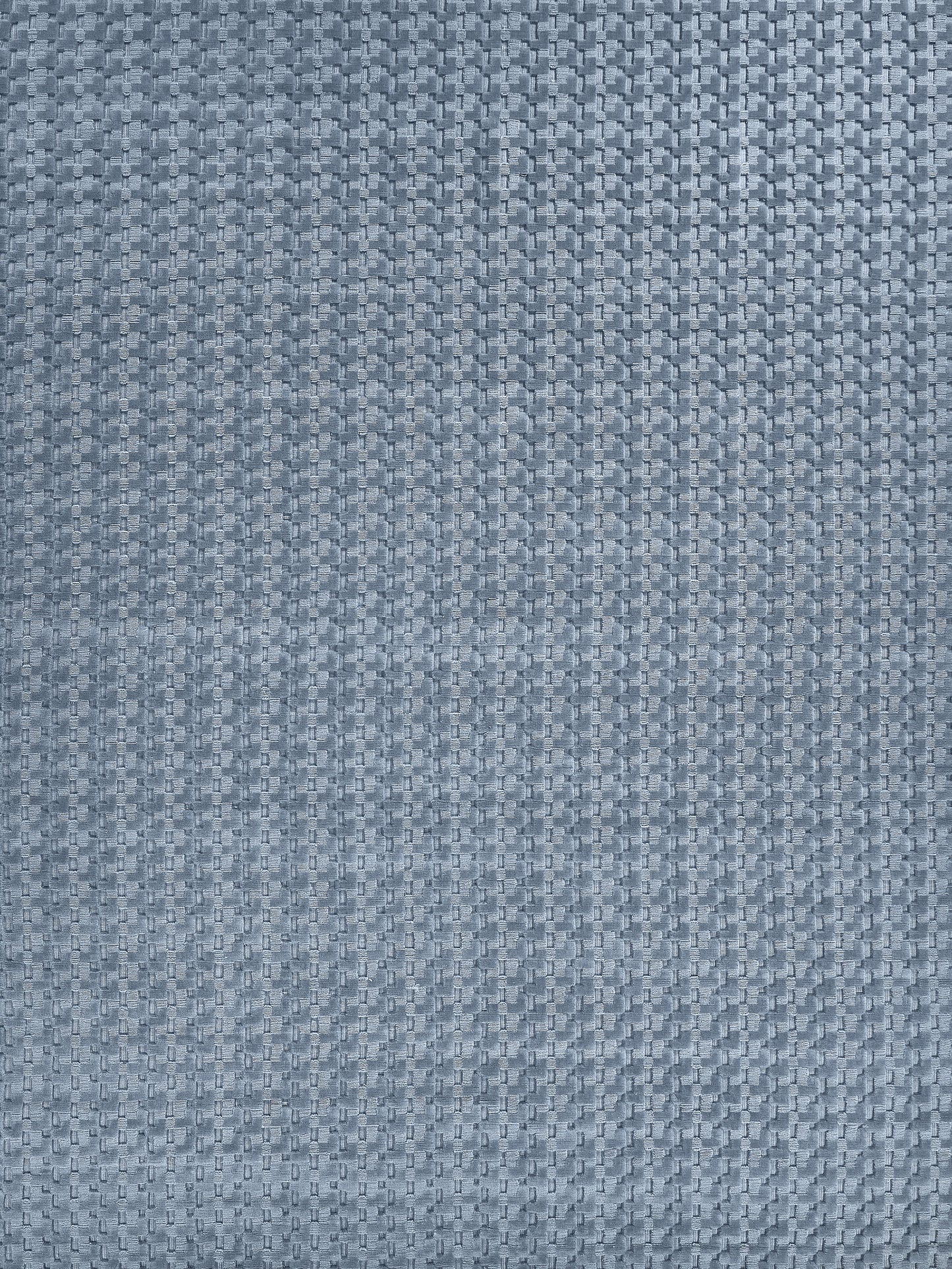 Close-up of blue micro-houndstooth woven rug with fine texture.