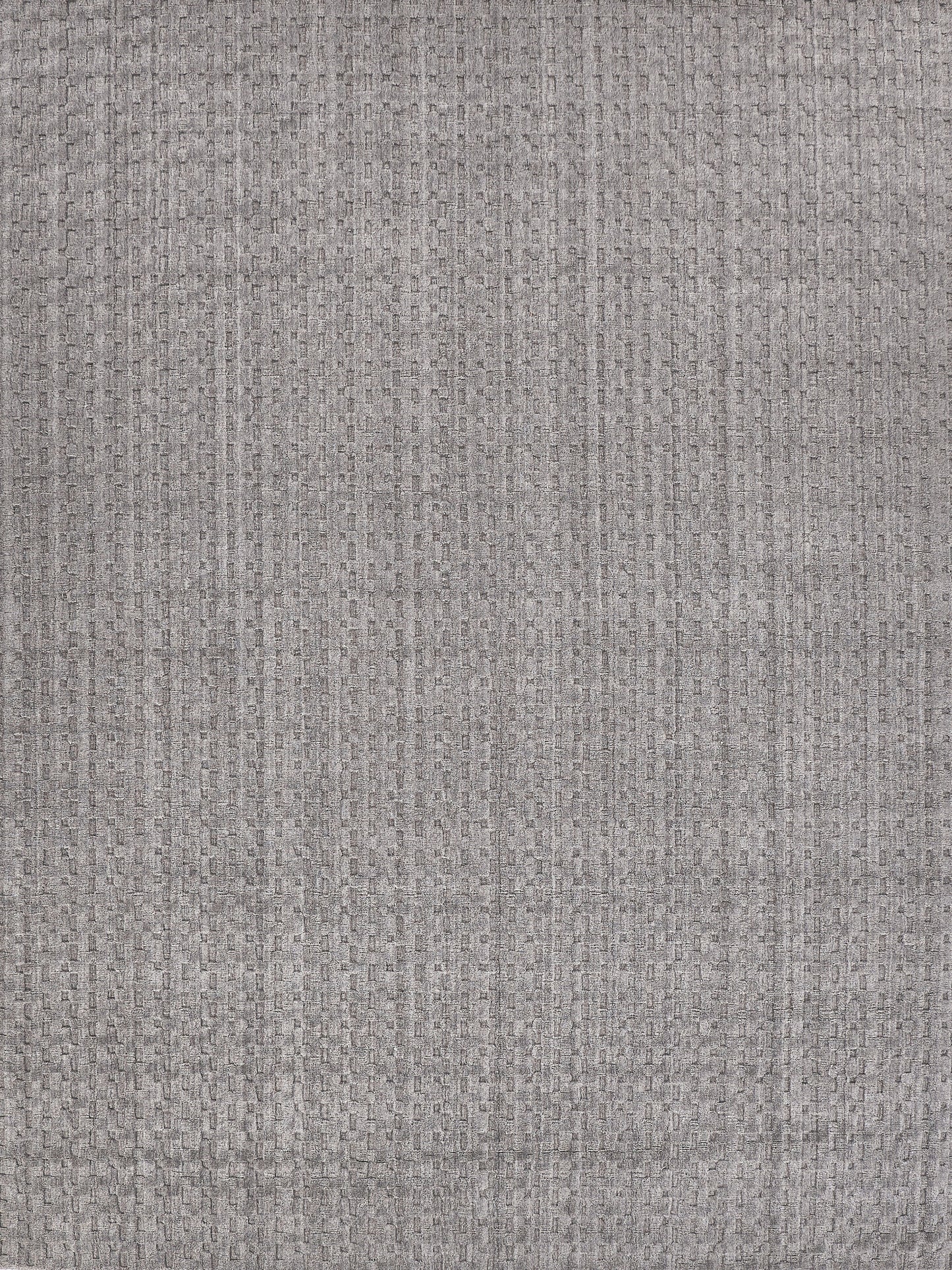 Grey woven rug with a subtle rectangular texture and soft matte finish; indoor hand-loomed rug, size 2' x 3'.