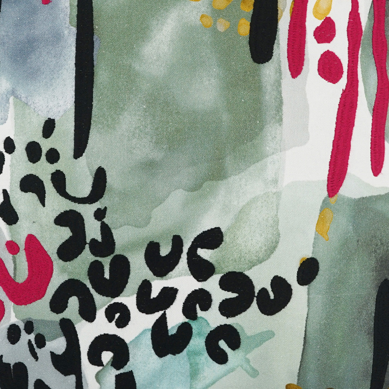 Pillow featuring an abstract pattern with watercolor greens, black curved motifs, pink drips, red accents and yellow specks.