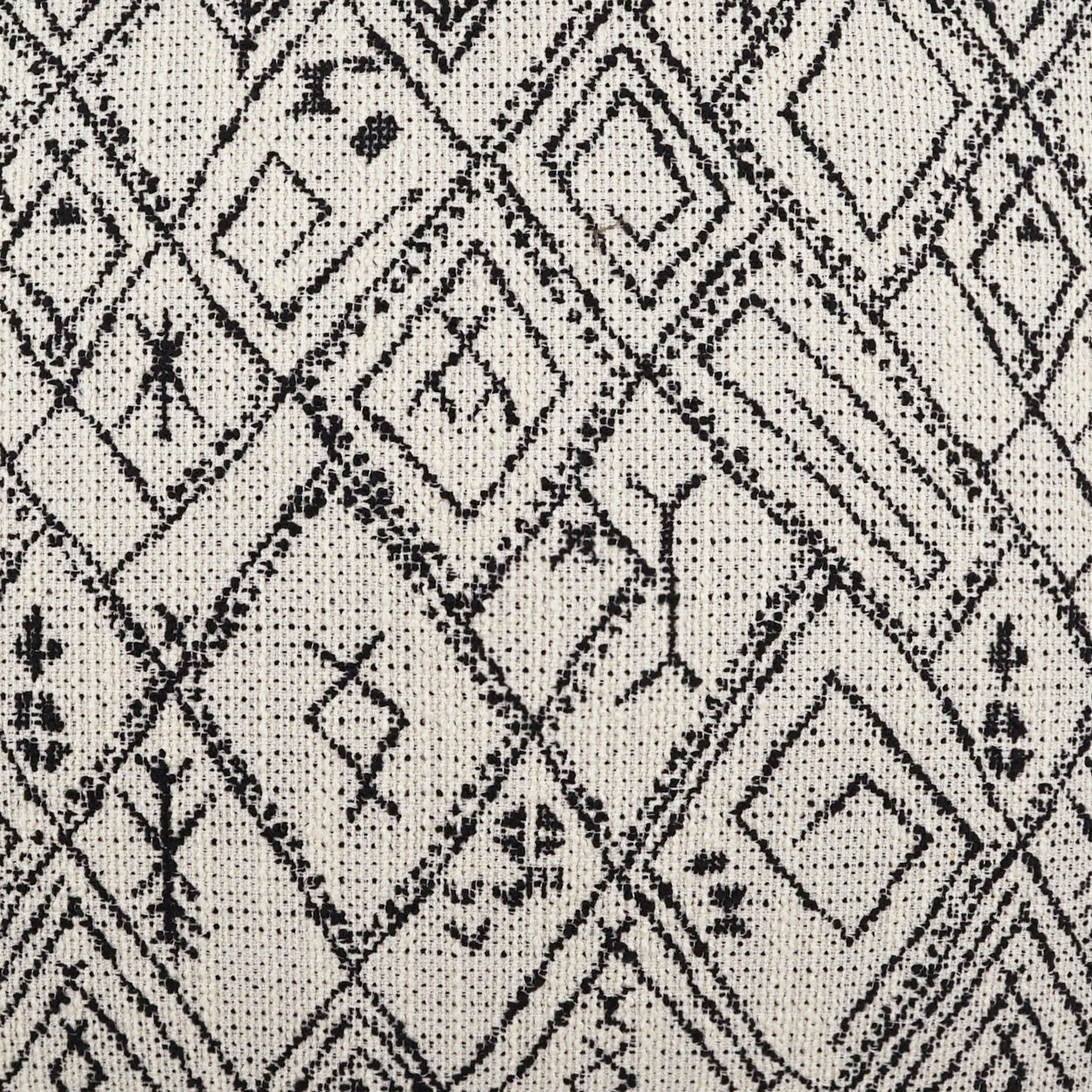 Beige woven pillow with a black diamond geometric pattern in a tribal boho style, 24" x 24