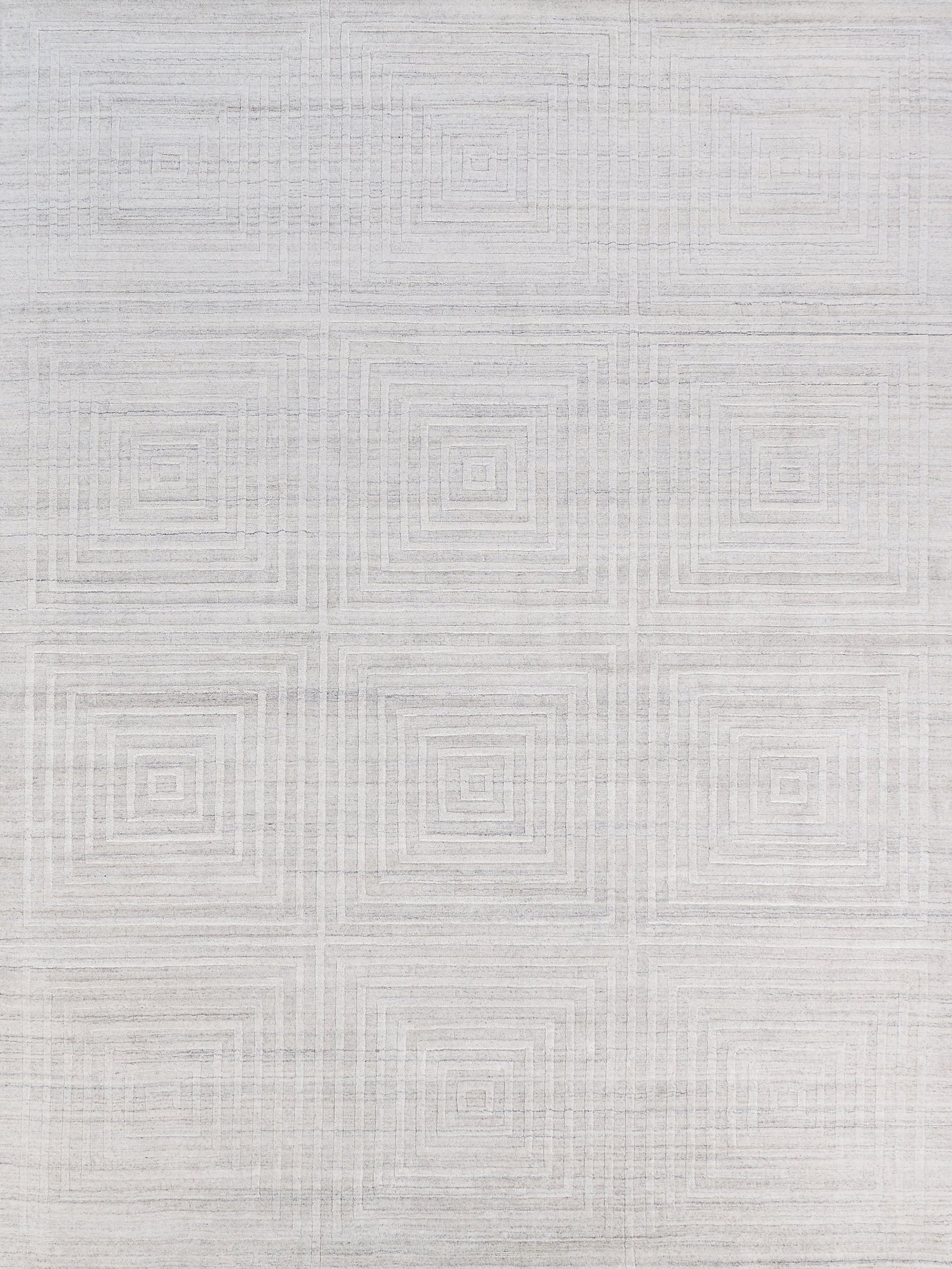 Textured area rug in soft gray with subtle linear geometric patterns, featuring concentric squares for a modern aesthetic.