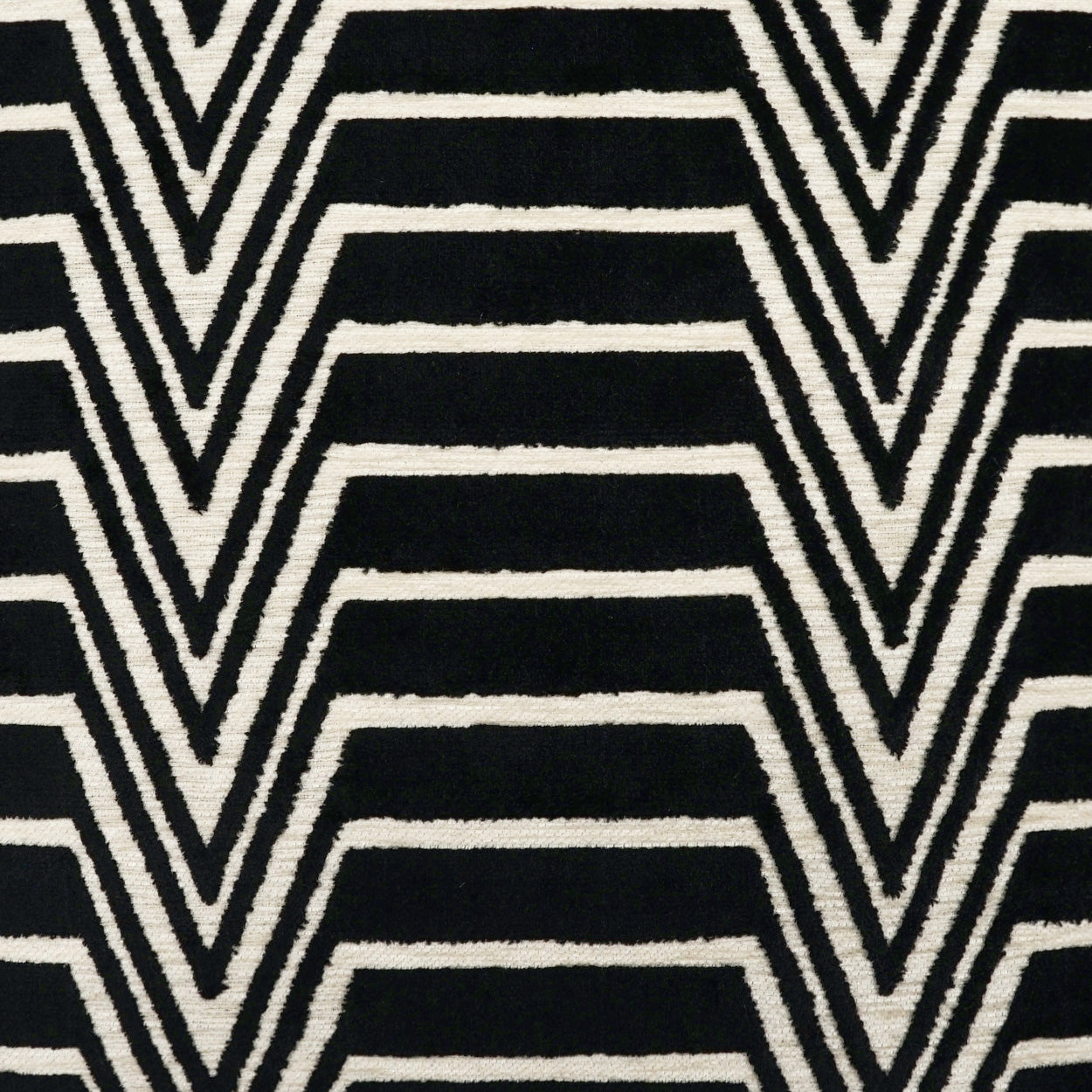 Black fabric with bold white chevron zigzag stripes & geometric pattern.