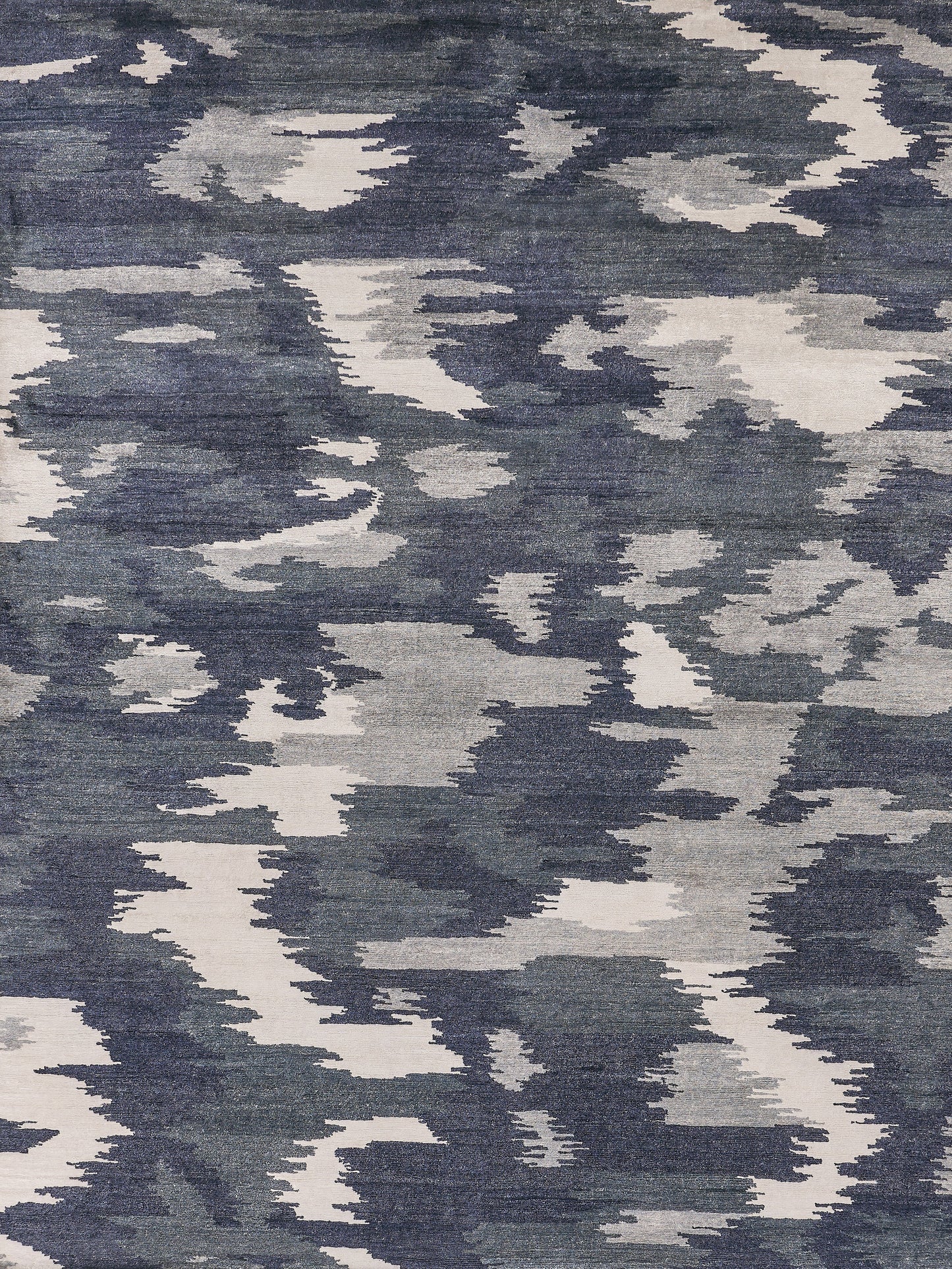 Textured area rug featuring a modern blue and cream abstract pattern, ideal for enhancing contemporary interiors.