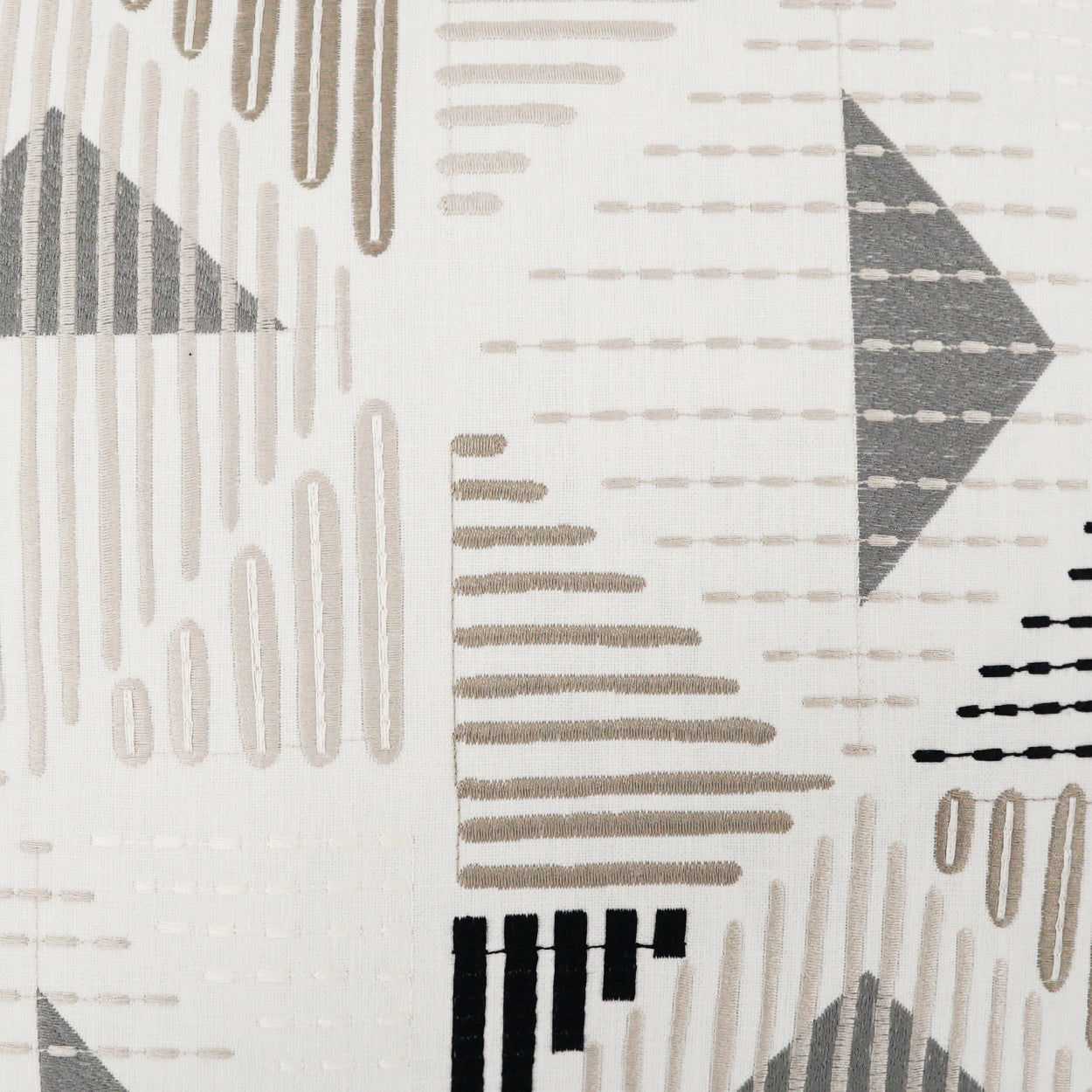 Geometric fabric in beige, taupe, gray and black with triangles and dashed lines; modern upholstery or drapery textile.