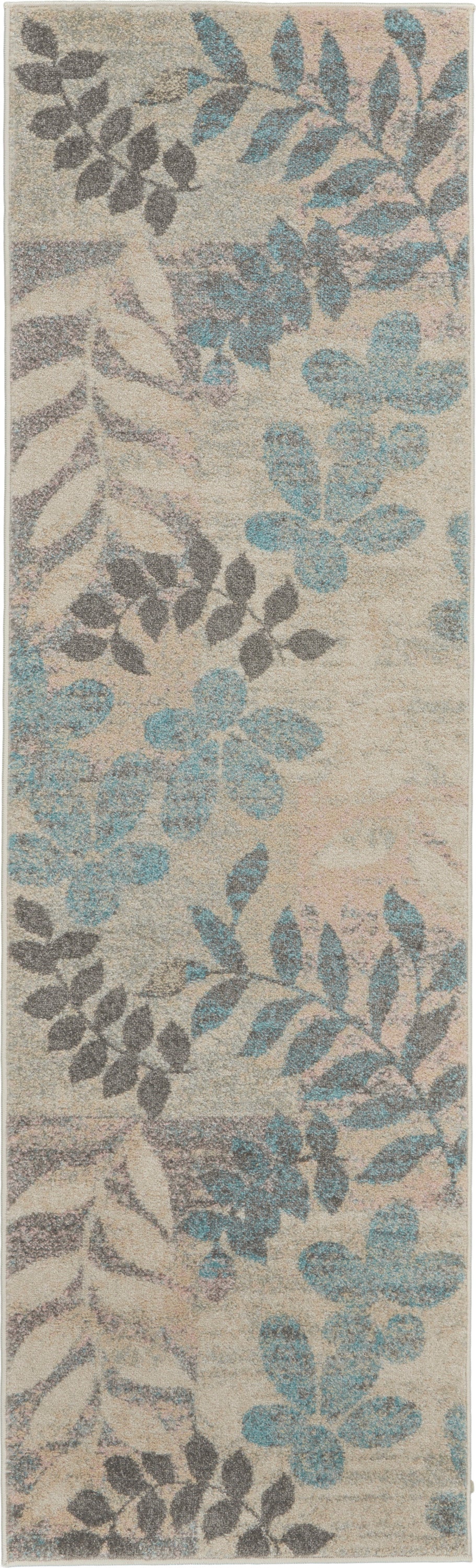Beige rectangular rug with blue and gray botanical leaf pattern; soft, textured pile for living room decor.