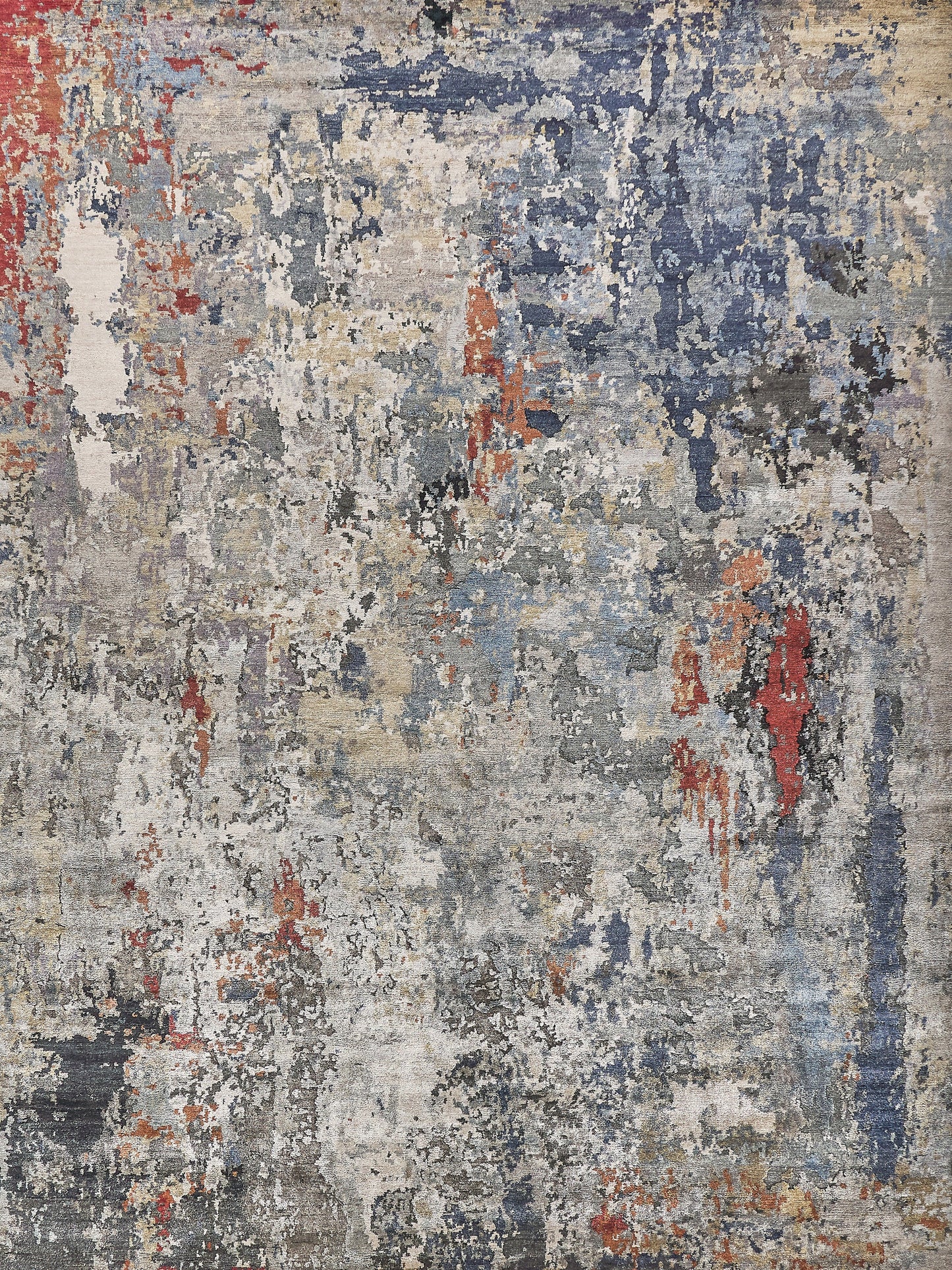Abstract distressed area rug with blue, gray, beige and red tones; modern painterly design.