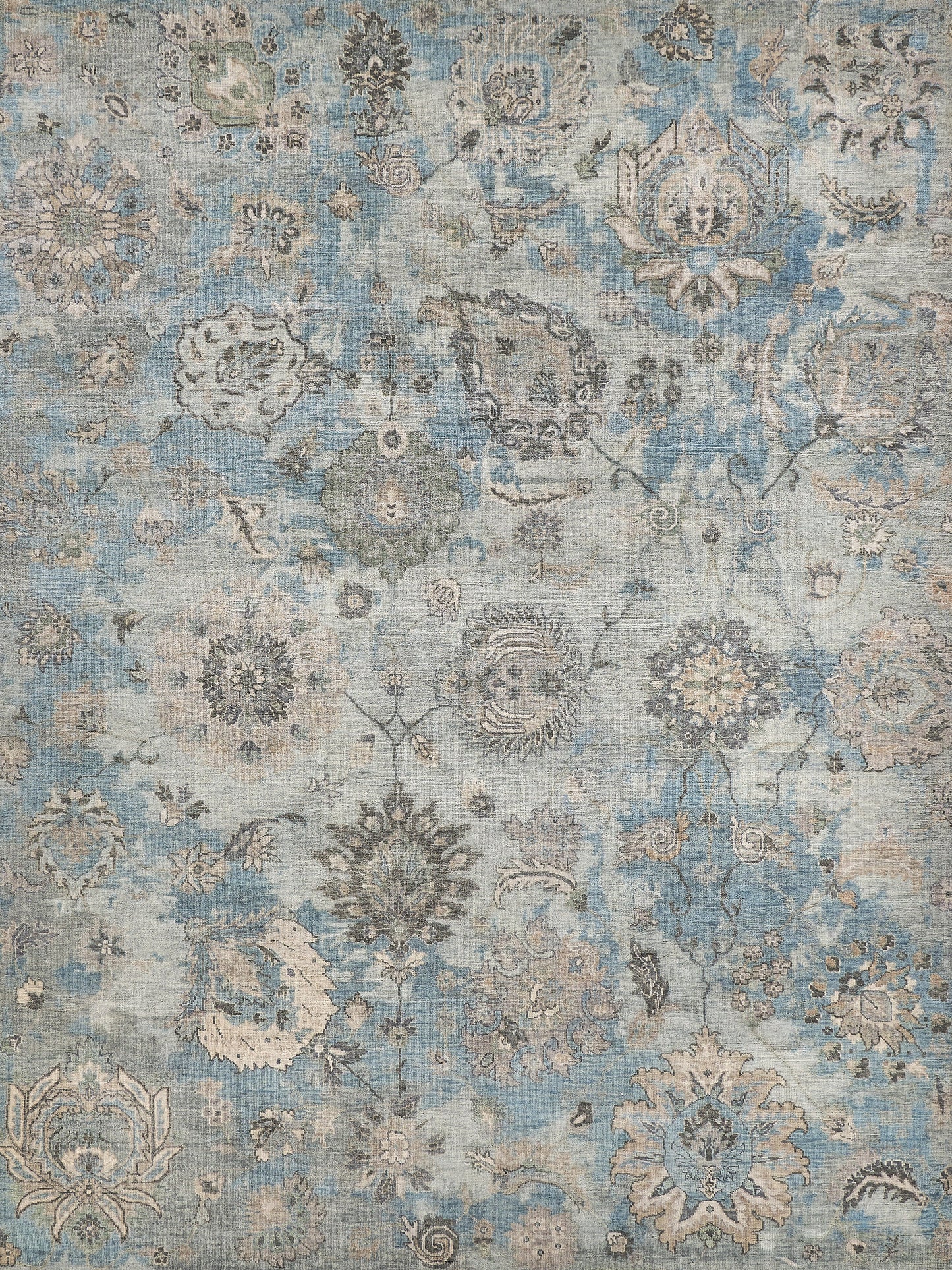Light blue vintage-style hand-knotted rectangle rug, 10' x 14', featuring intricate floral and paisley patterns in muted beige and gray tones.