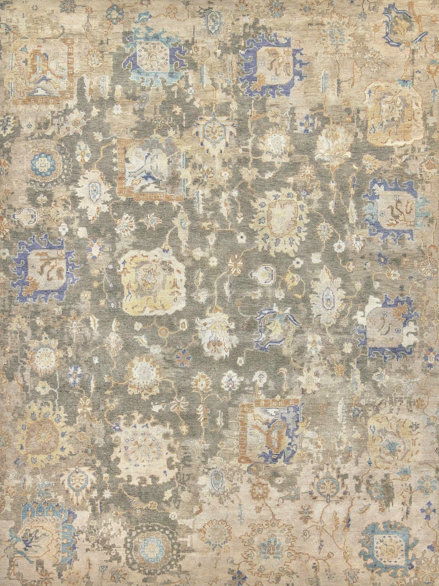 Rectangular woven rug with a distressed vintage patchwork medallion pattern in beige, gray, ivory and blue.