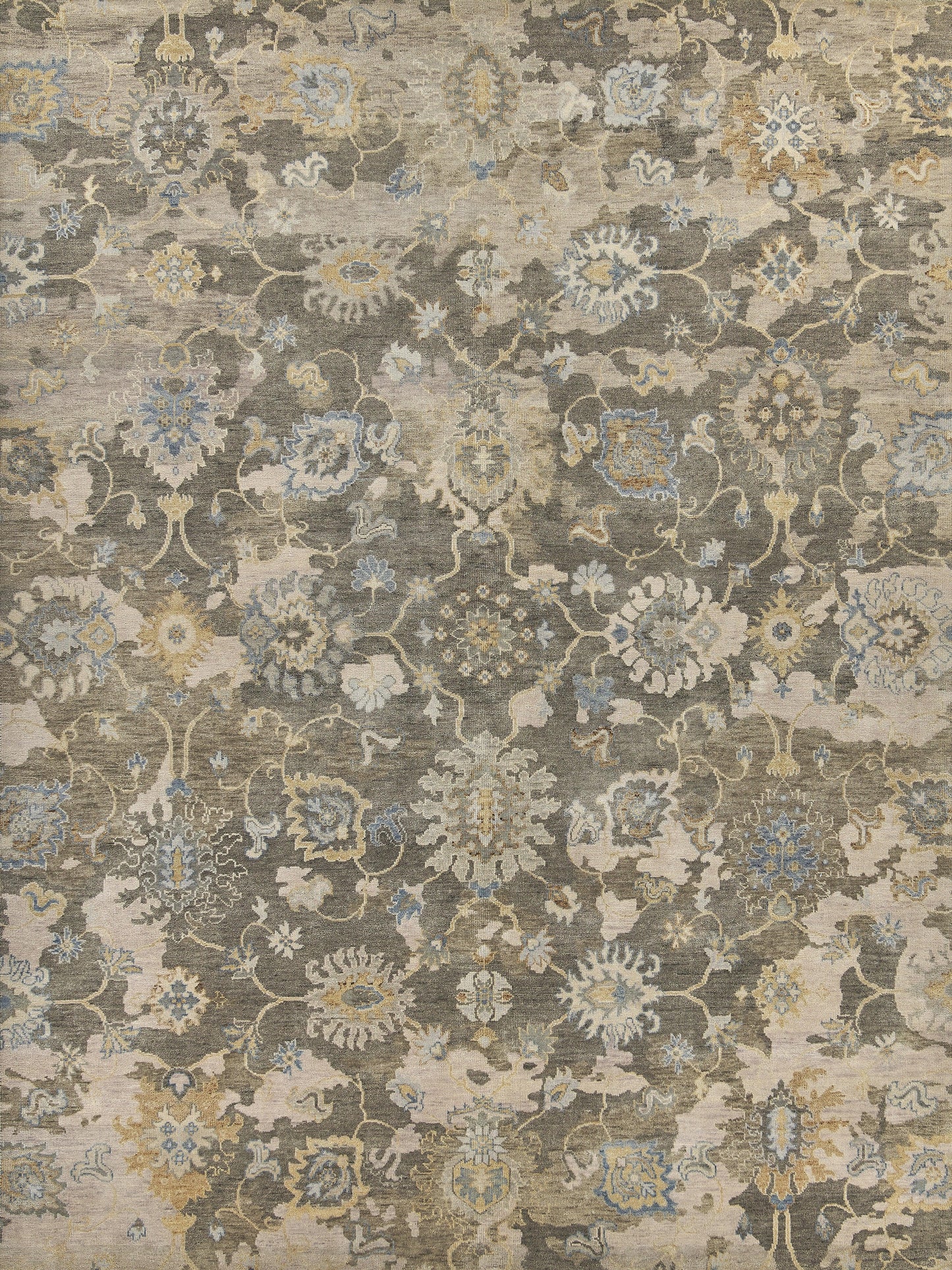 Distressed oriental rug with a muted beige, gray, blue and ivory floral damask pattern.