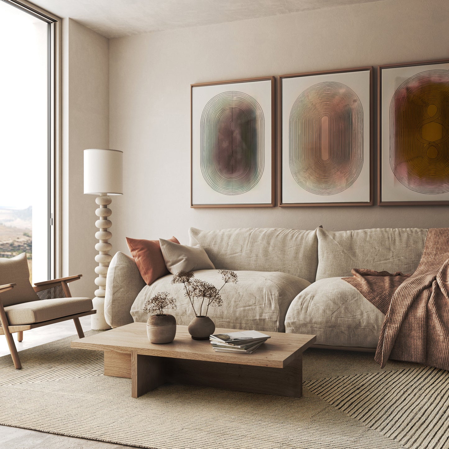 Neutral living room with beige sofa, wooden coffee table, three abstract prints, a tall floor lamp, and a rectangular 6' x 9' hand-knotted rug.