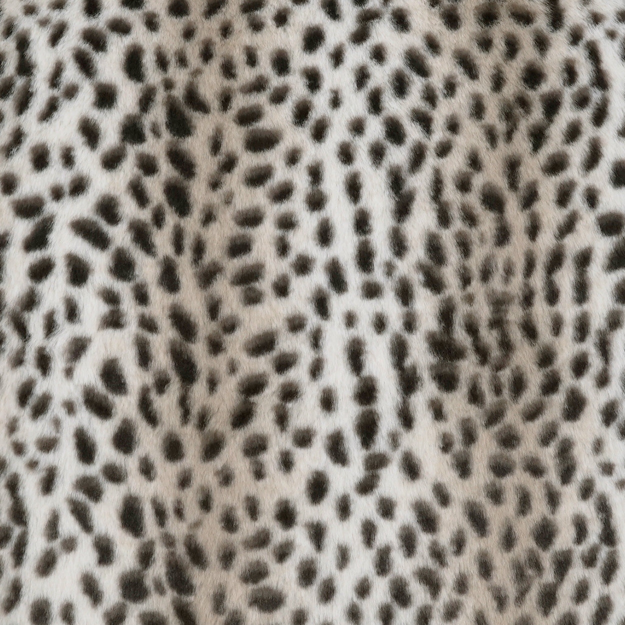 Leopard print faux fur on a beige background with black and dark brown spots; plush, soft-textured pillow fabric, 24" x 24