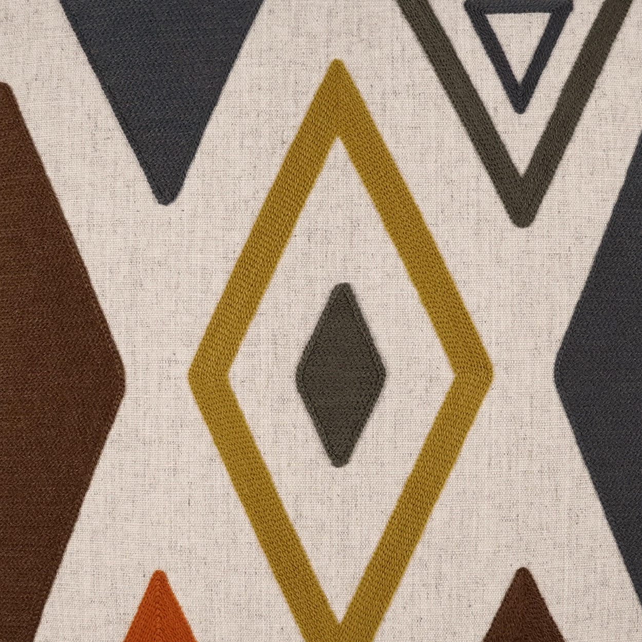 Geometric diamond pattern on beige fabric; mustard diamonds with a dark inner diamond, and gray and brown triangles.
