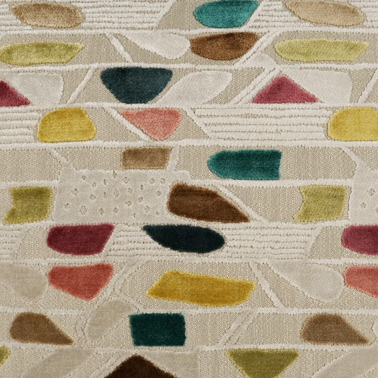 Beige woven pillow with multicolor abstract shapes in yellow, teal, green, pink and brown; modern geometric pattern.