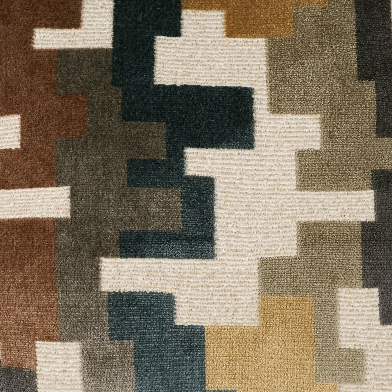 Woven area rug with pixelated camouflage blocks in brown, tan, olive, gray, navy and cream.