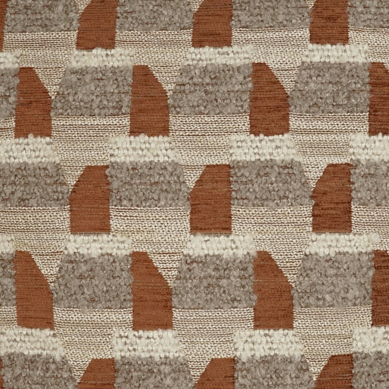 Textured geometric rug fabric with tan, taupe and brown stepped arches in a repeating tufted pattern.
