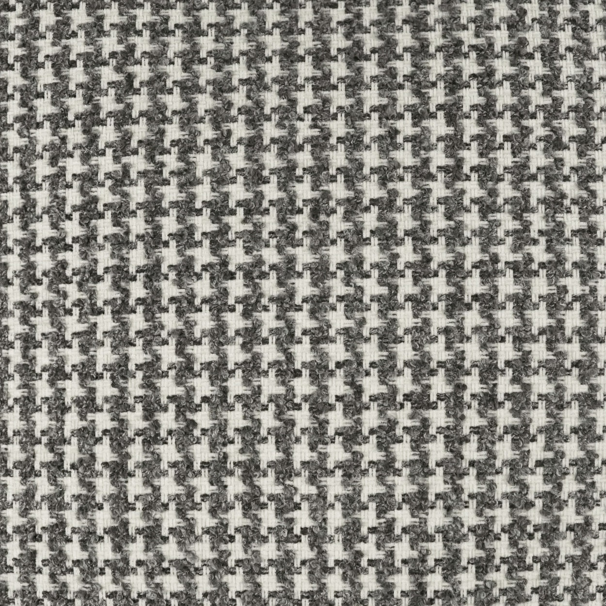 Close-up of gray and white houndstooth woven fabric texture.