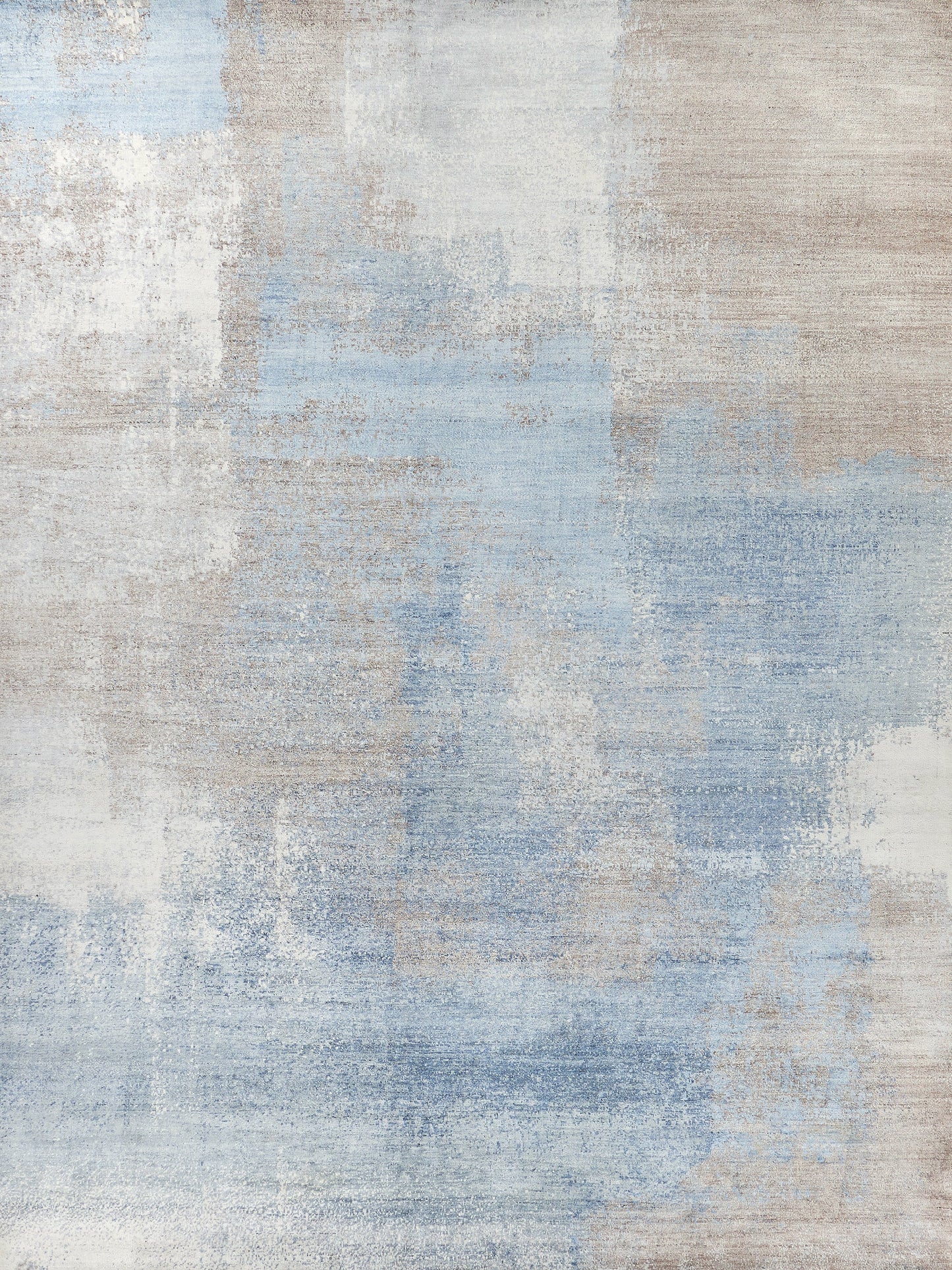 Abstract area rug with a blend of soft blues and neutral tones, featuring a textured appearance perfect for modern decor.
