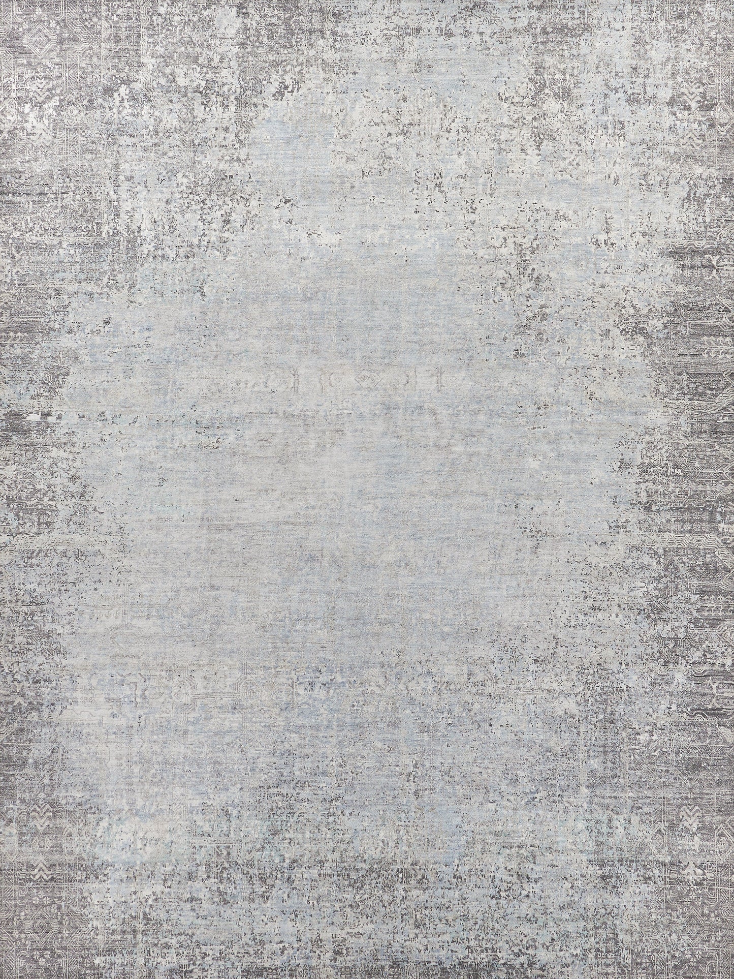 Light blue and gray distressed area rug with intricate patterns, soft texture, and vintage style, perfect for adding elegance to any room.