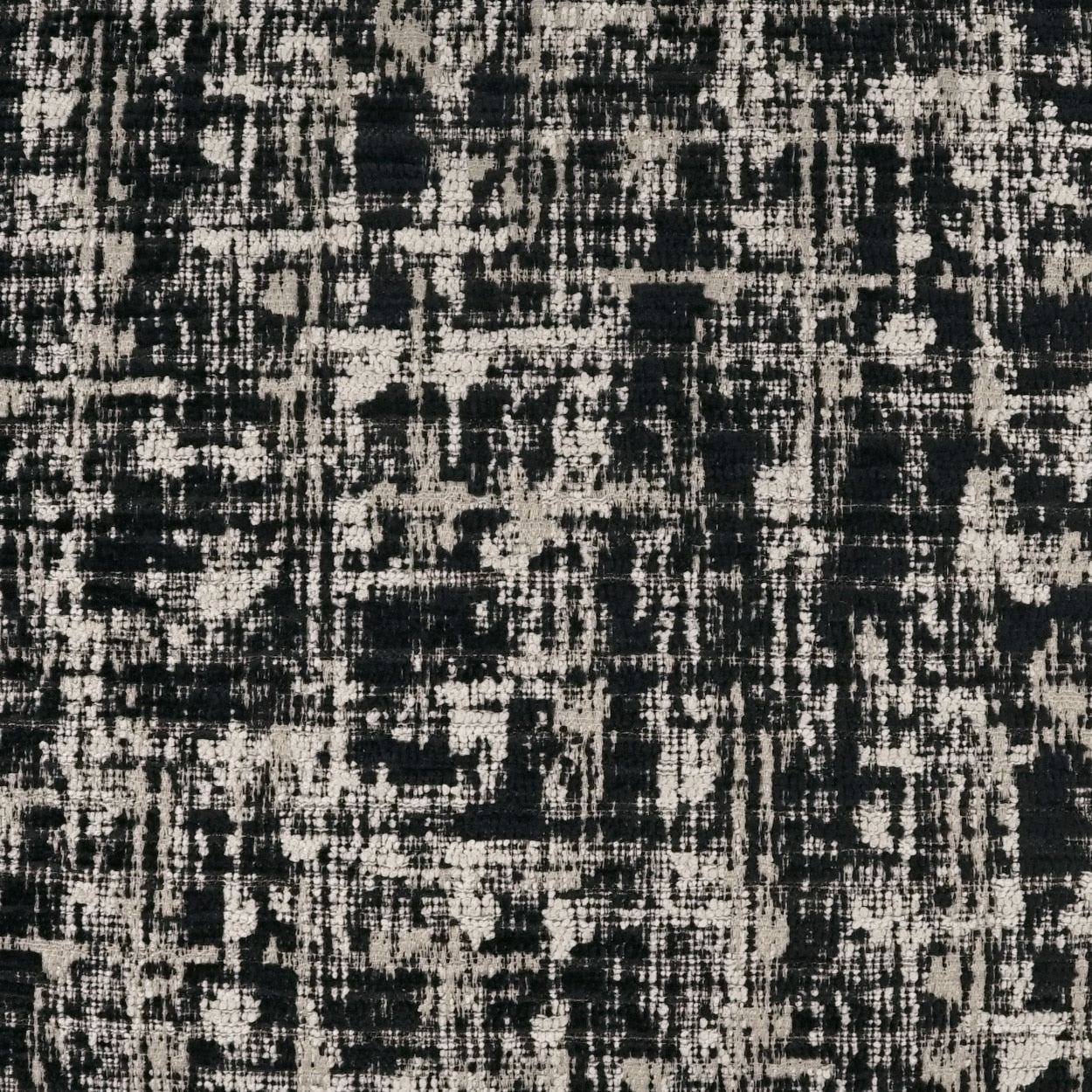 Abstract black and beige distressed woven fabric texture; contemporary upholstery or rug.
