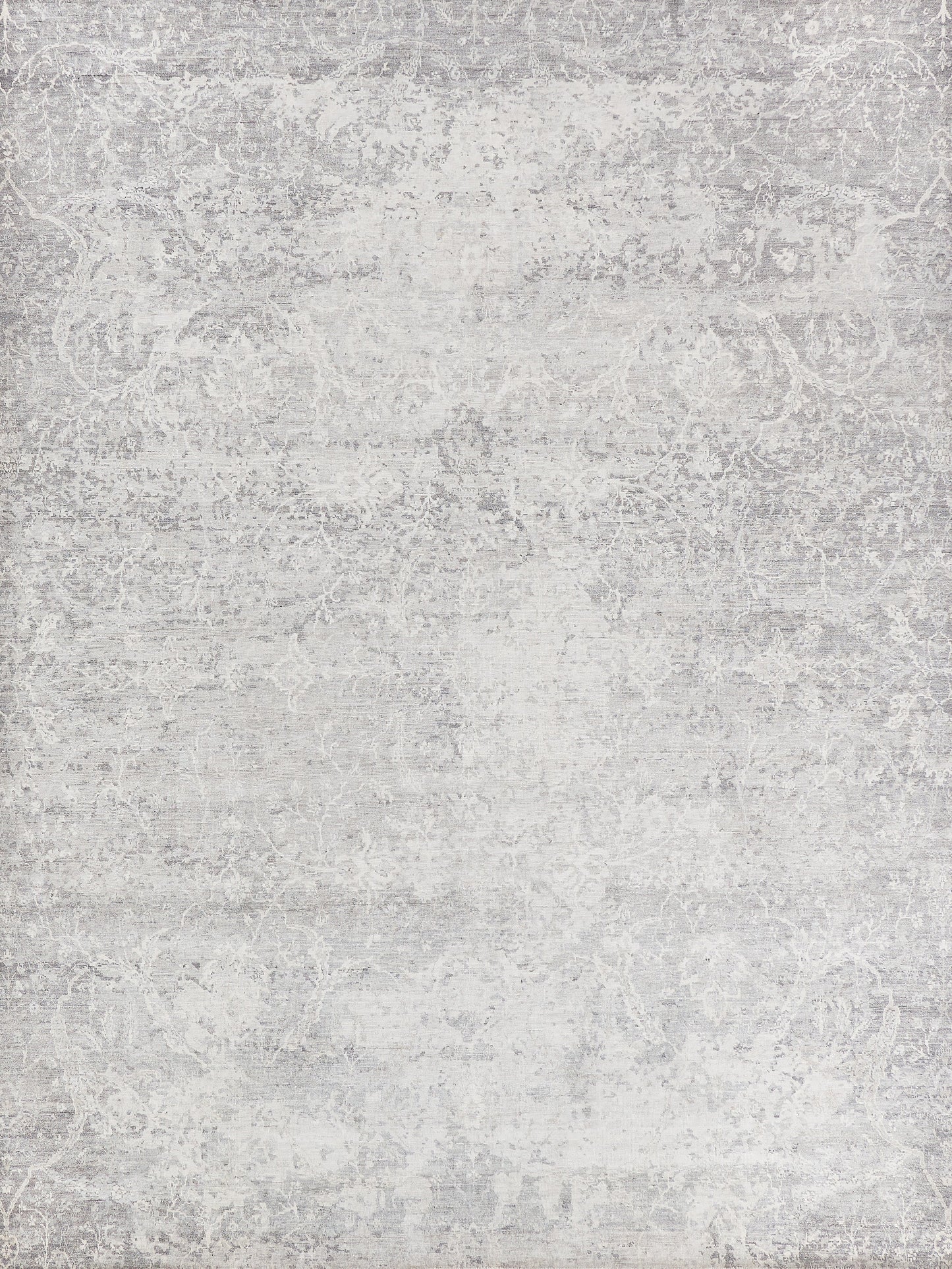 Silver area rug with intricate light gray patterns, soft texture, and a rectangular shape, ideal for modern interiors.