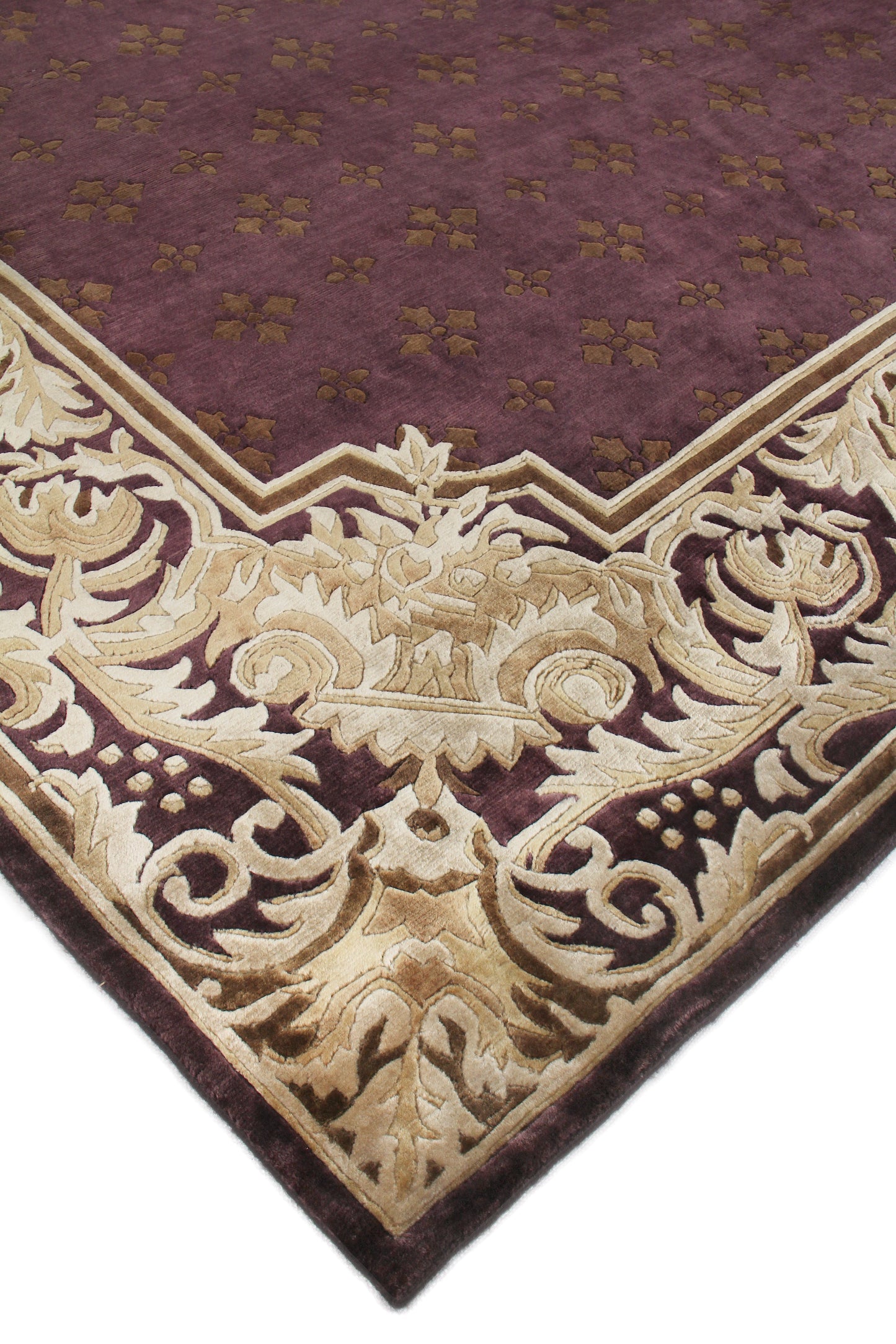 Maroon Persian-style area rug with a beige-gold ornate scrolling border & cream floral motifs.