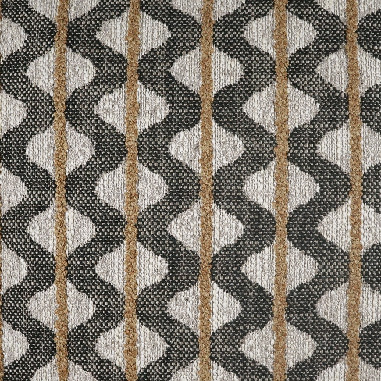 Geometric patterned fabric with vertical gold stripes & black zigzag diamonds on beige background, woven texture.