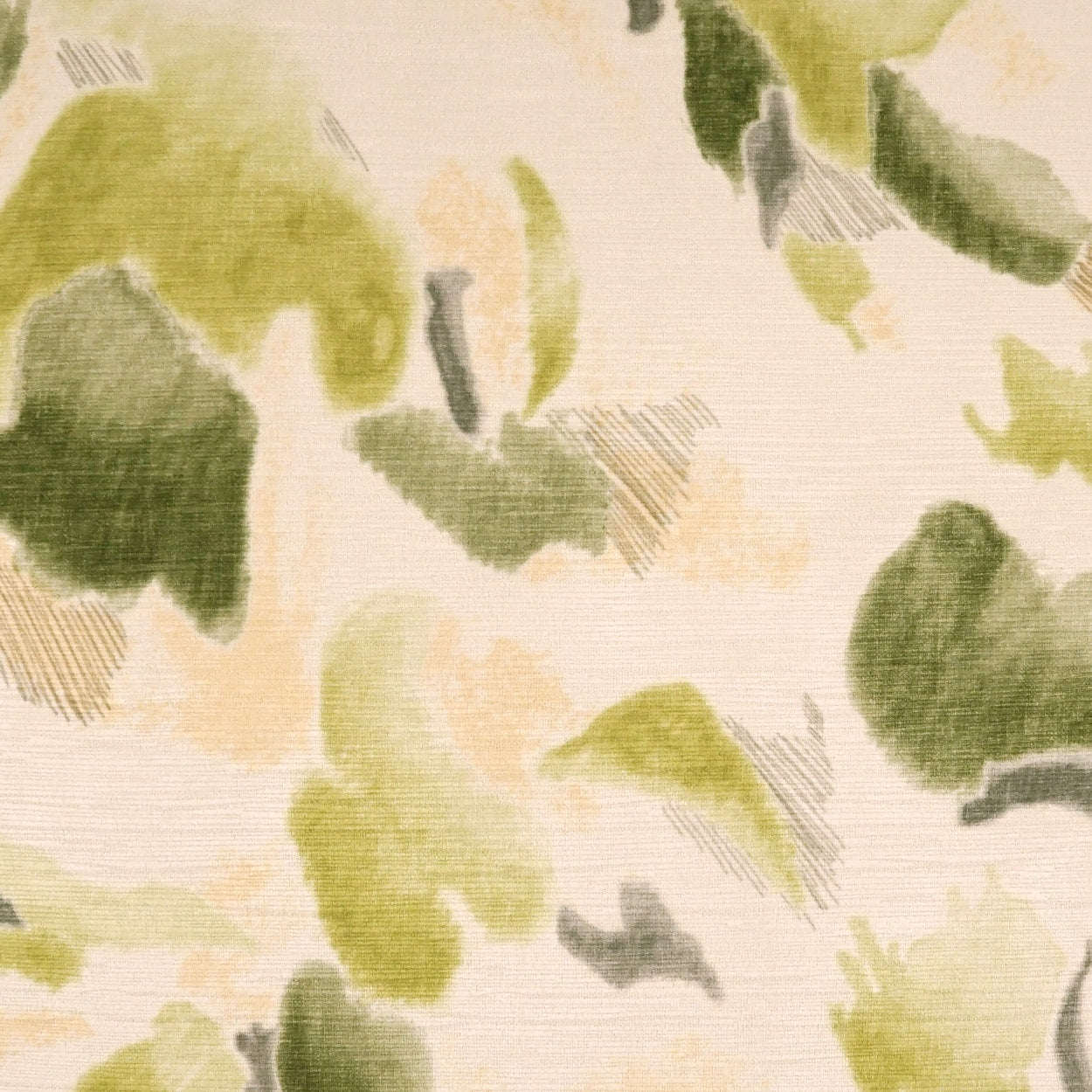 Soft abstract green and beige camouflage fabric print with watercolor-like splotches on cream backdrop.