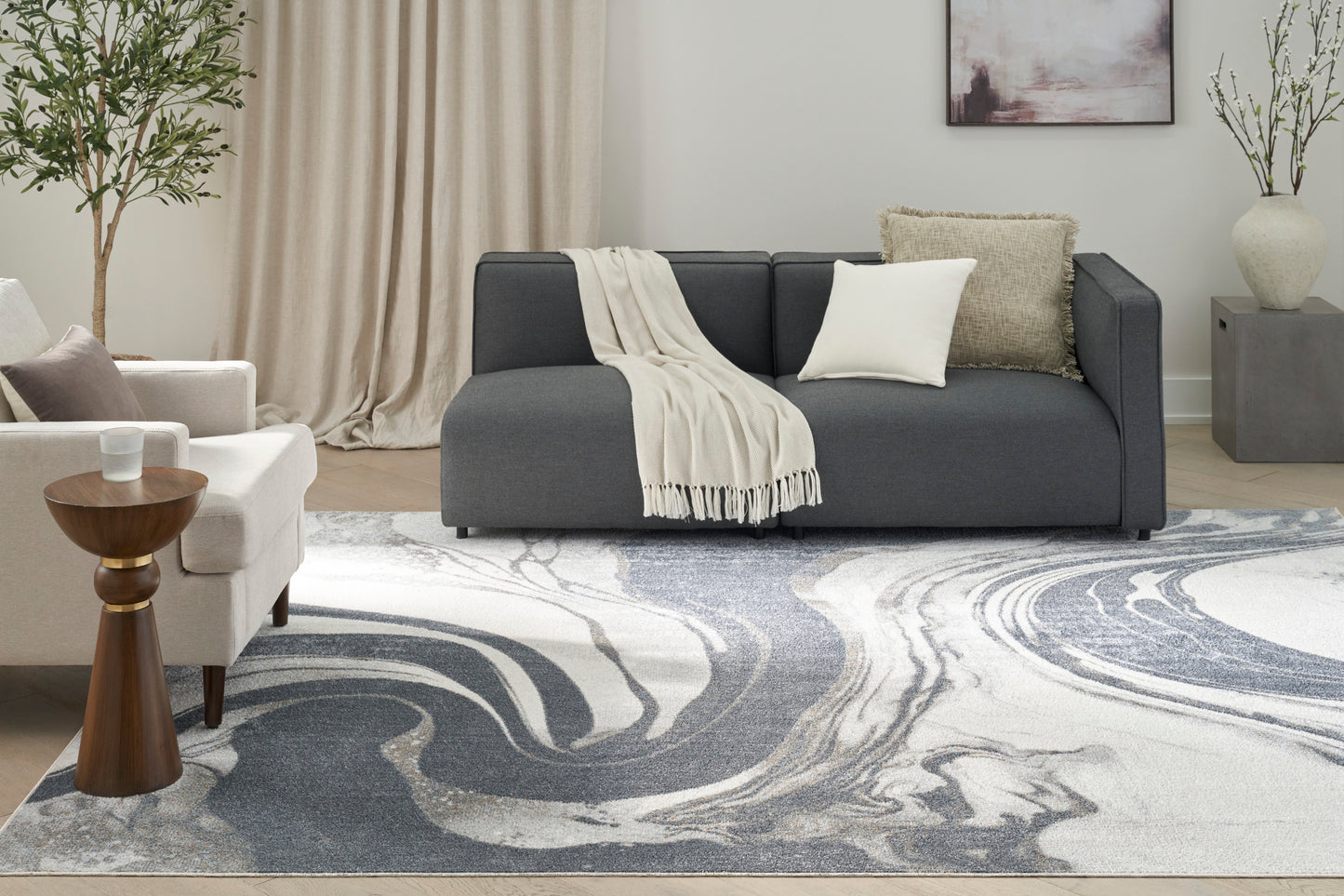 Gray and cream swirl area rug in a modern living room setting (8' x 10').